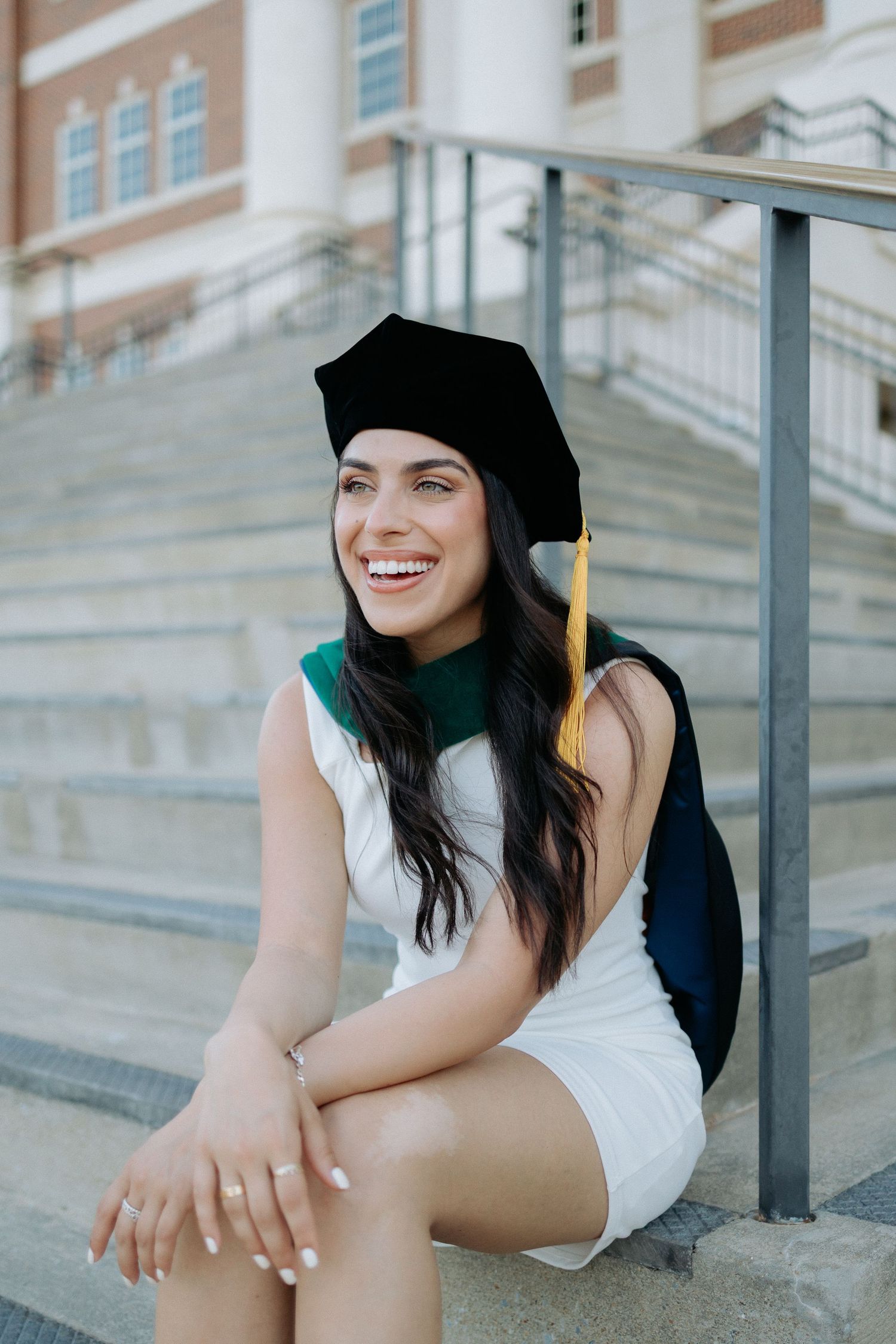 Graduate celebrating during a portrait session in Auburn, Alabama with a fun, candid and joyful vibe