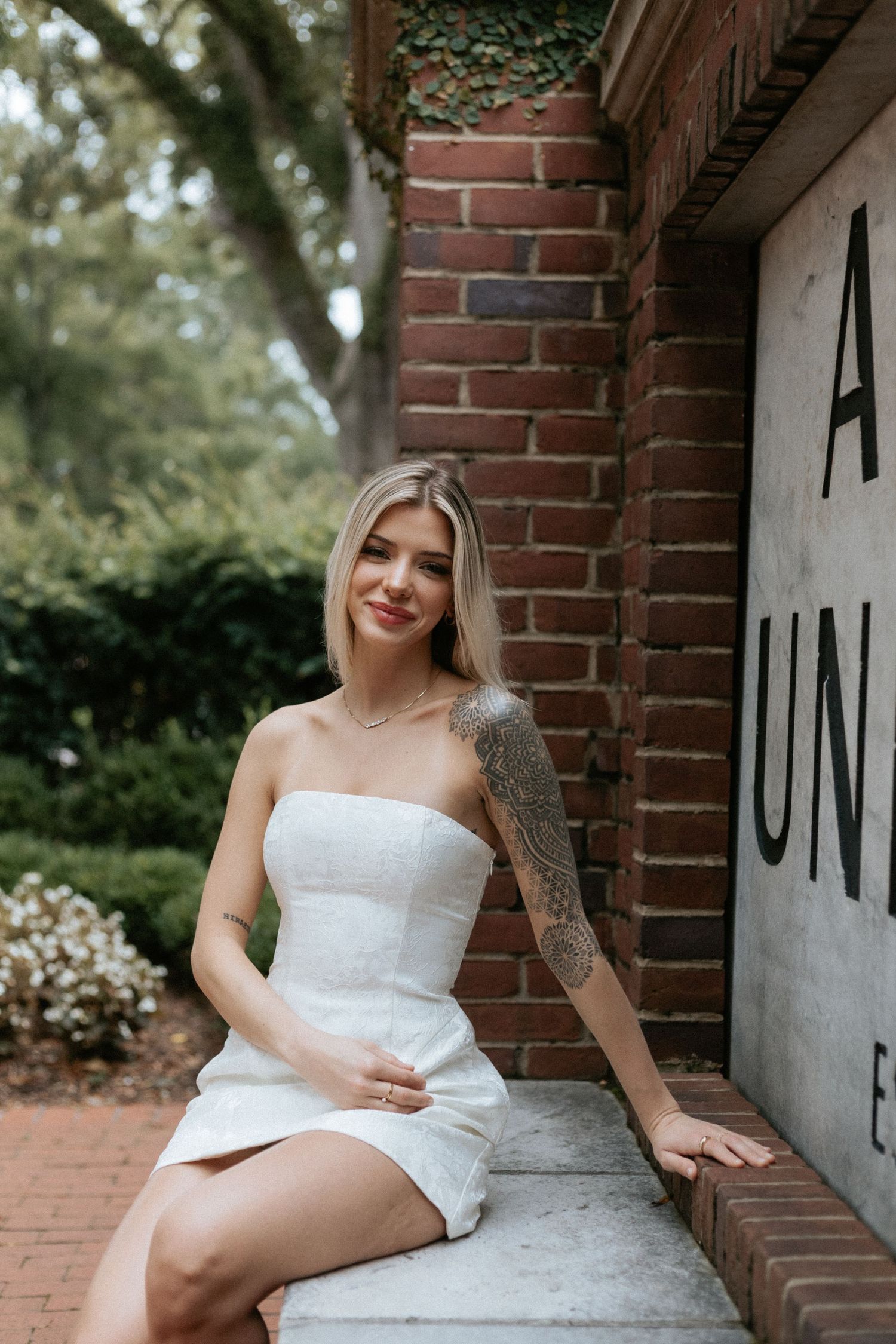 Graduate celebrating during a portrait session in Auburn, Alabama with a fun, candid and joyful vibe