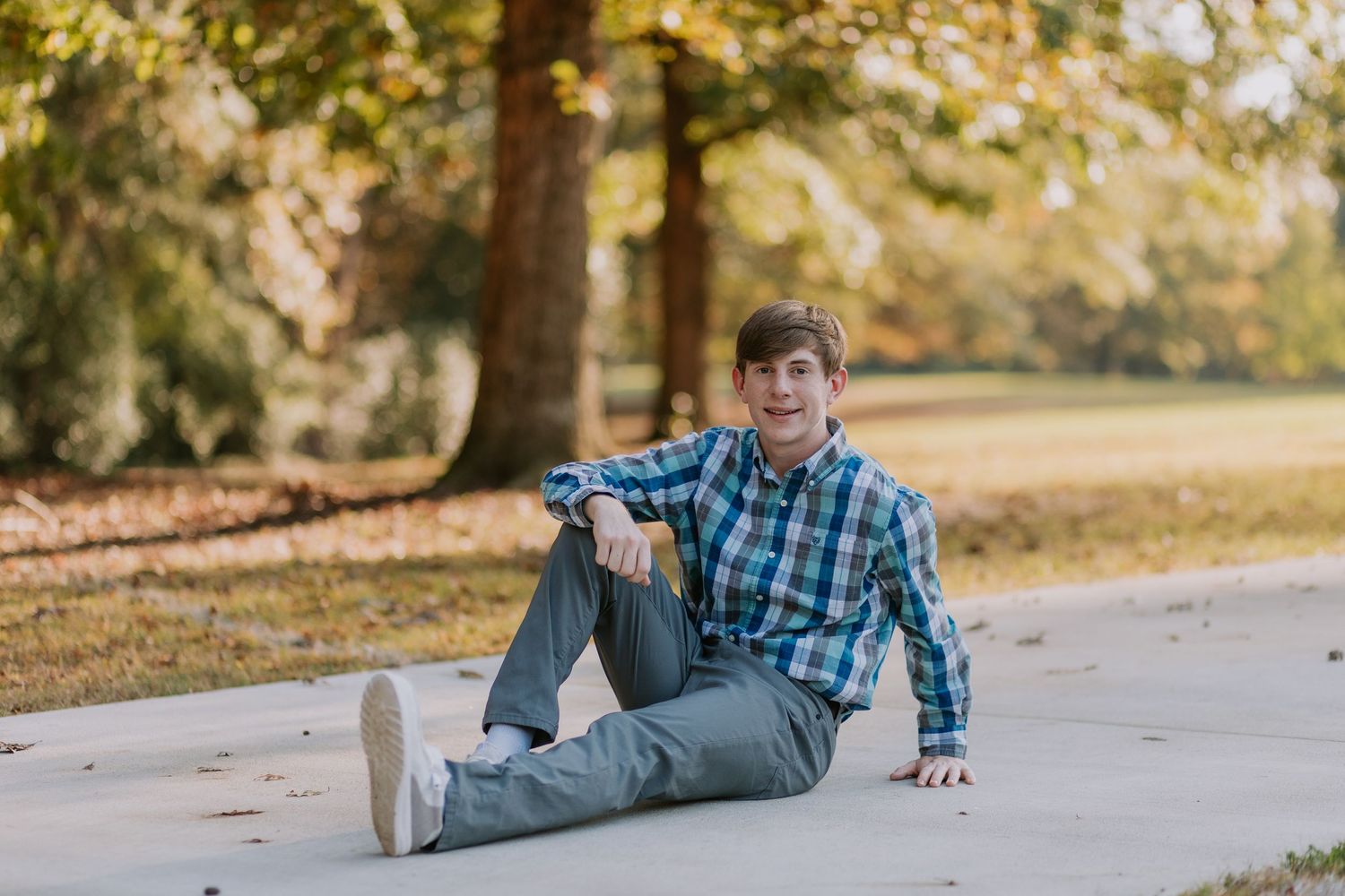 Graduate celebrating during a portrait session in Auburn, Alabama with a fun, candid and joyful vibe