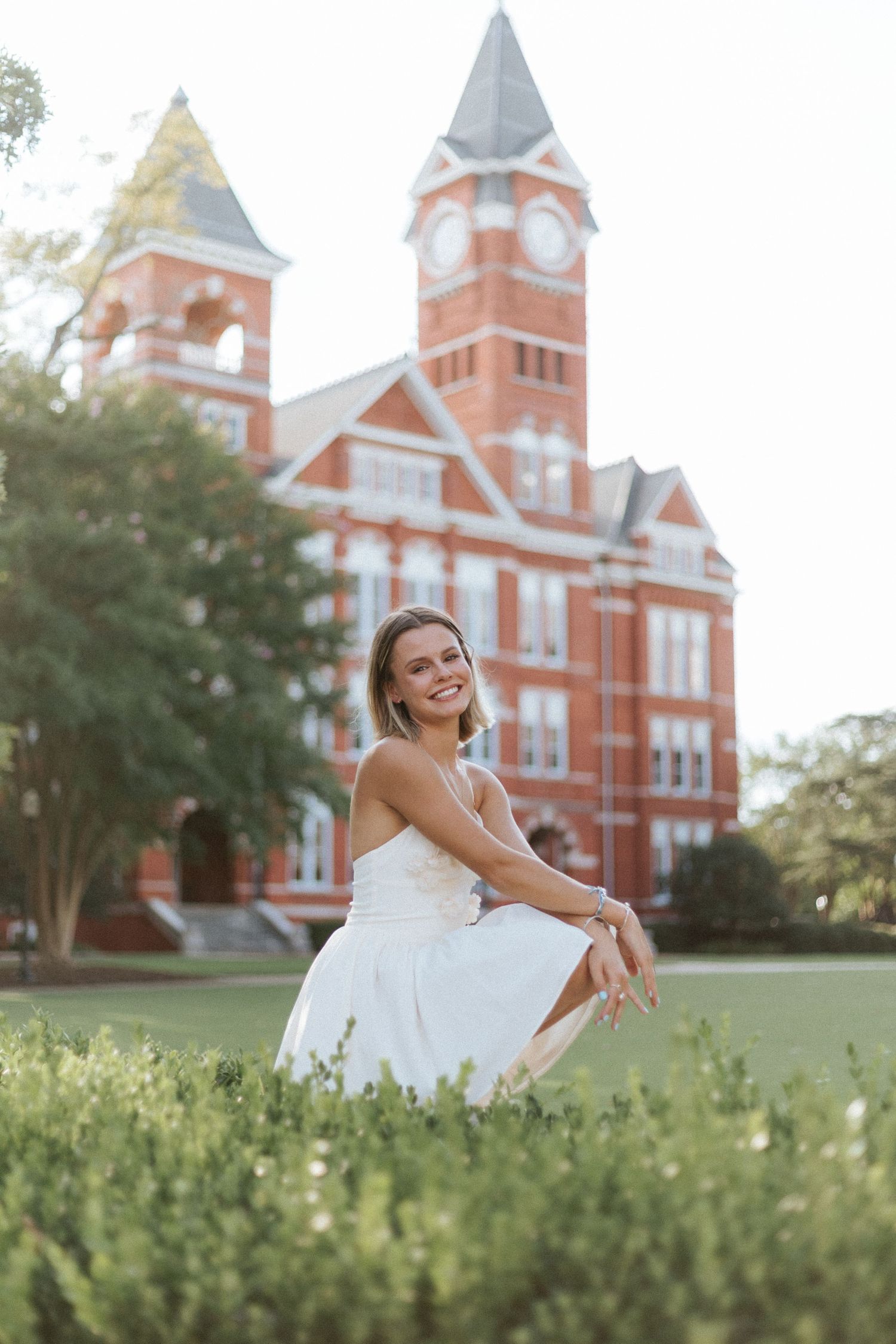 Graduate celebrating during a portrait session in Auburn, Alabama with a fun, candid and joyful vibe
