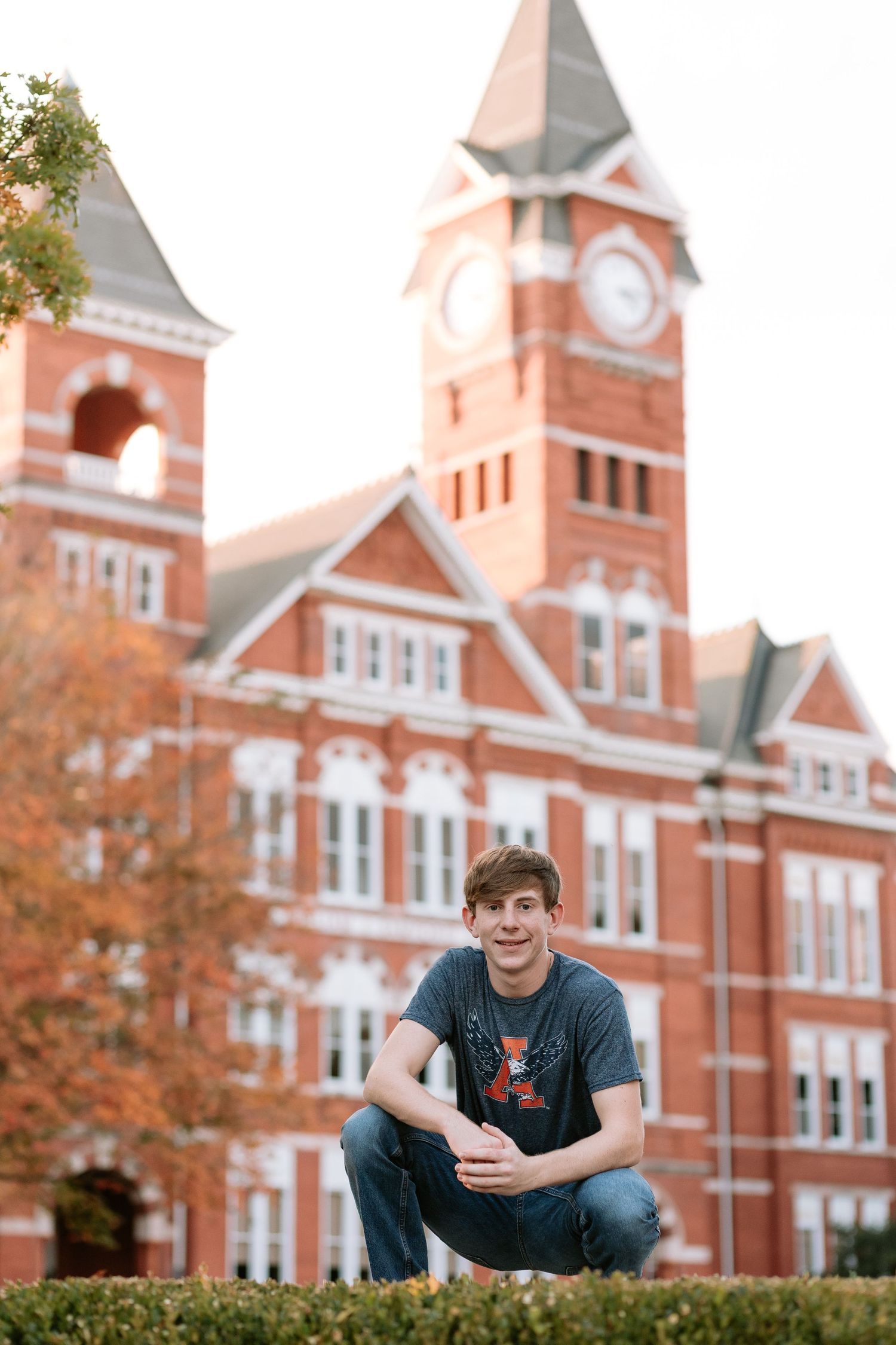 Graduate celebrating during a portrait session in Auburn, Alabama with a fun, candid and joyful vibe