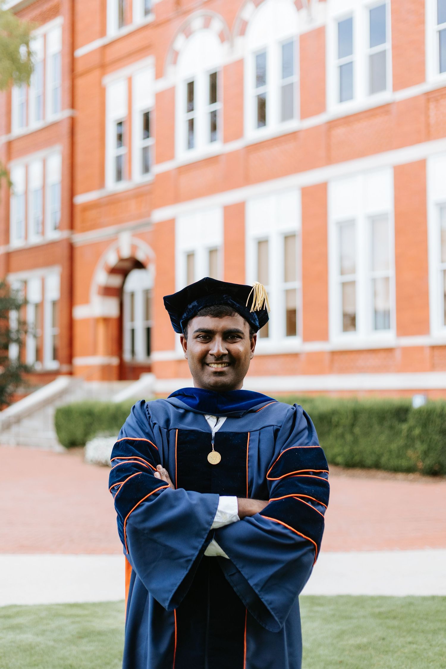 Graduate celebrating during a portrait session in Auburn, Alabama with a fun, candid and joyful vibe