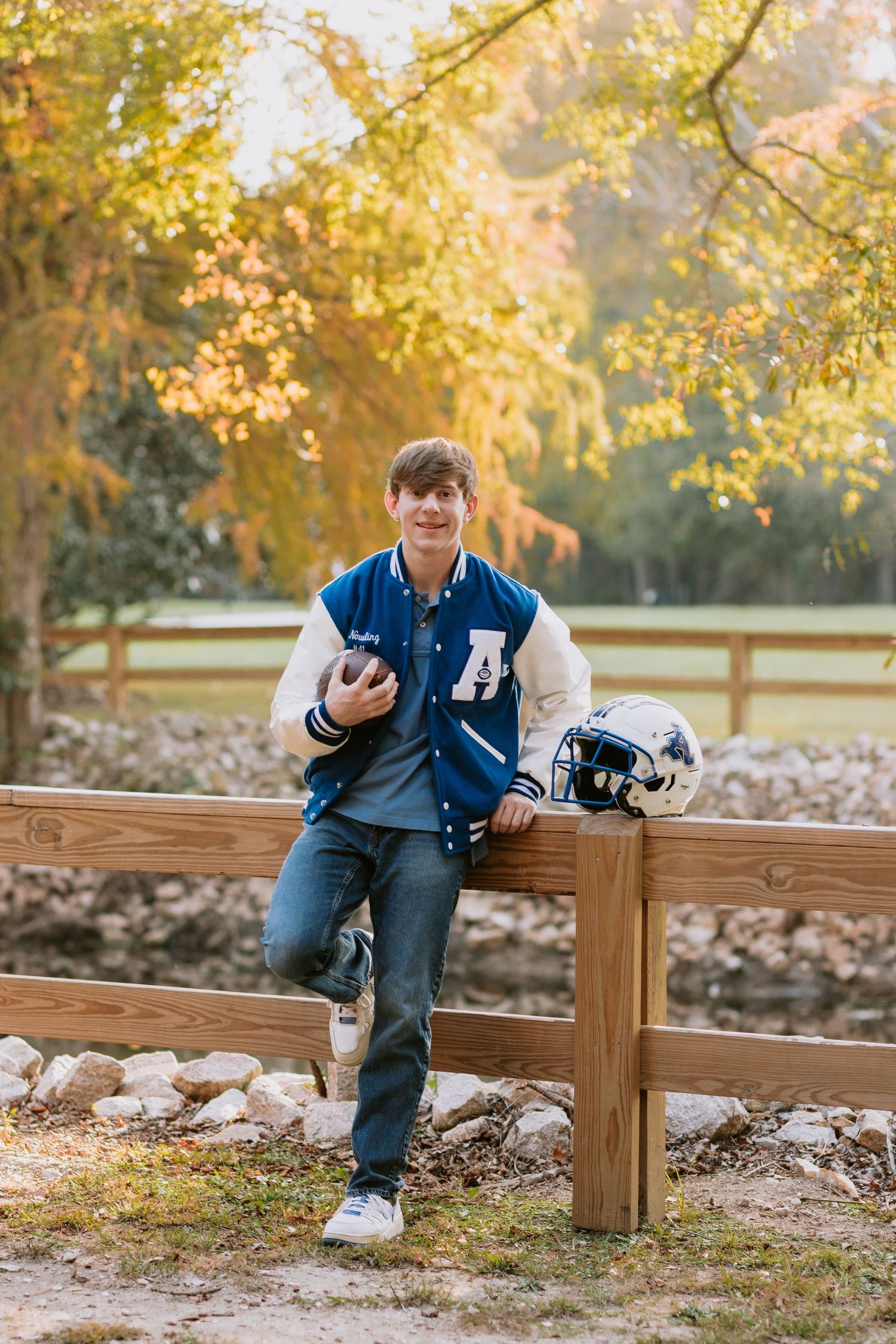 Graduate celebrating during a portrait session in Auburn, Alabama with a fun, candid and joyful vibe