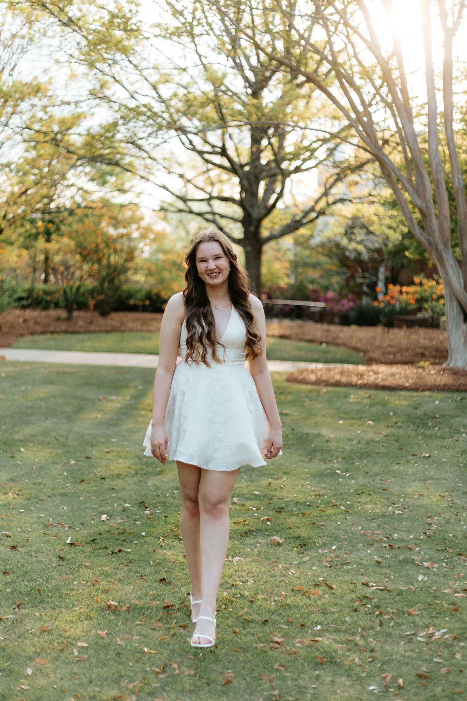 Graduate celebrating during a portrait session in Walt's on The Roof in Auburn, Alabama with a fun, candid and joyful vibe