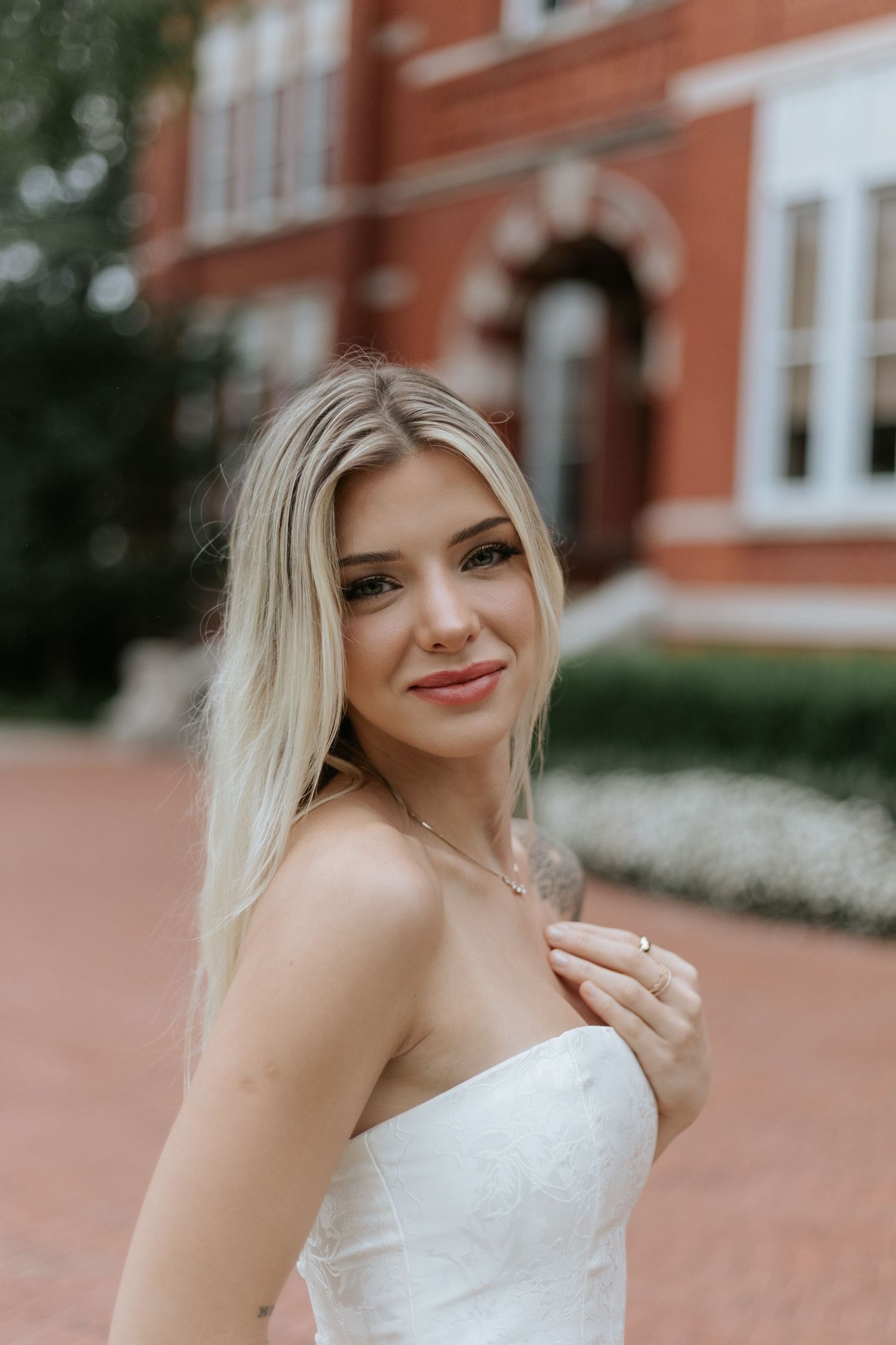 Graduate celebrating during a portrait session in Auburn, Alabama with a fun, candid and joyful vibe