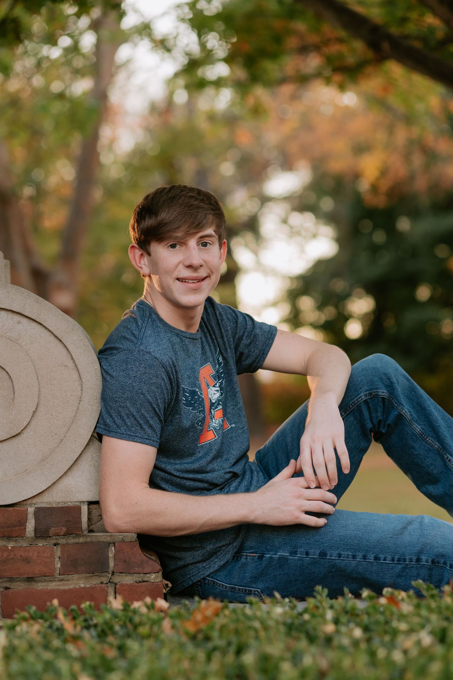Graduate celebrating during a portrait session in Auburn, Alabama with a fun, candid and joyful vibe