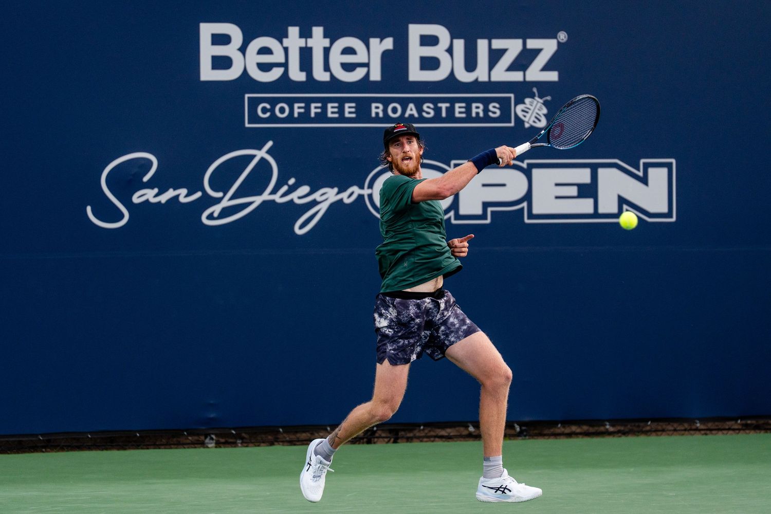 Tennis player hitting forehand at Better Buzz Coffee Roasters San Diego Open tournament.