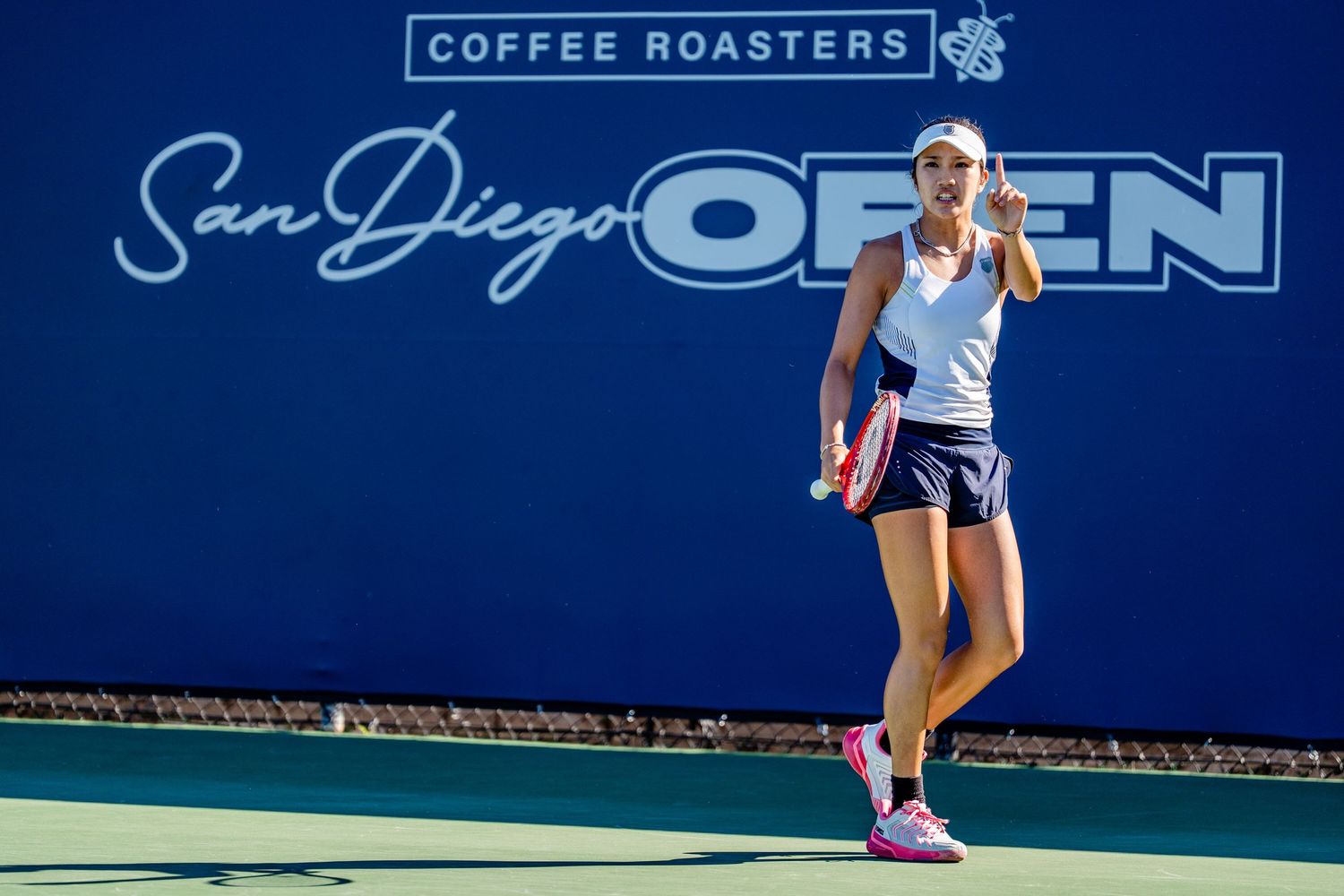 Female tennis player celebrates point at San Diego Open Coffee Roasters tournament.