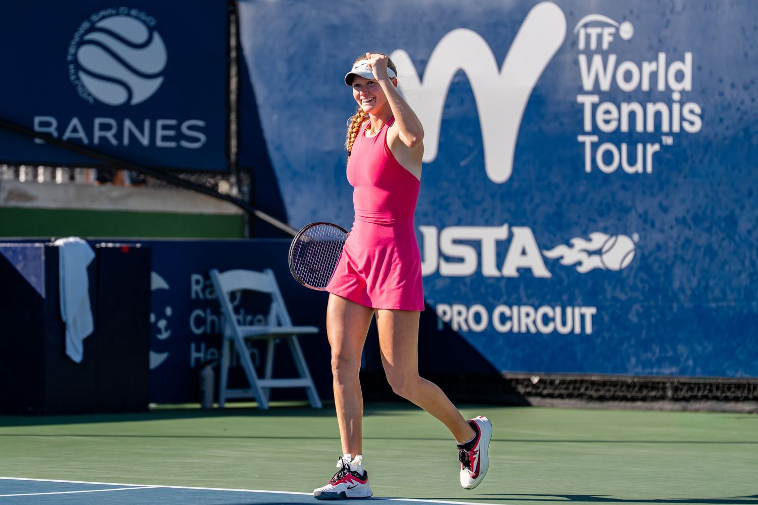 Female tennis player in pink outfit celebrating a point at the ITF World Tennis Tour USTA Pro Circuit event.