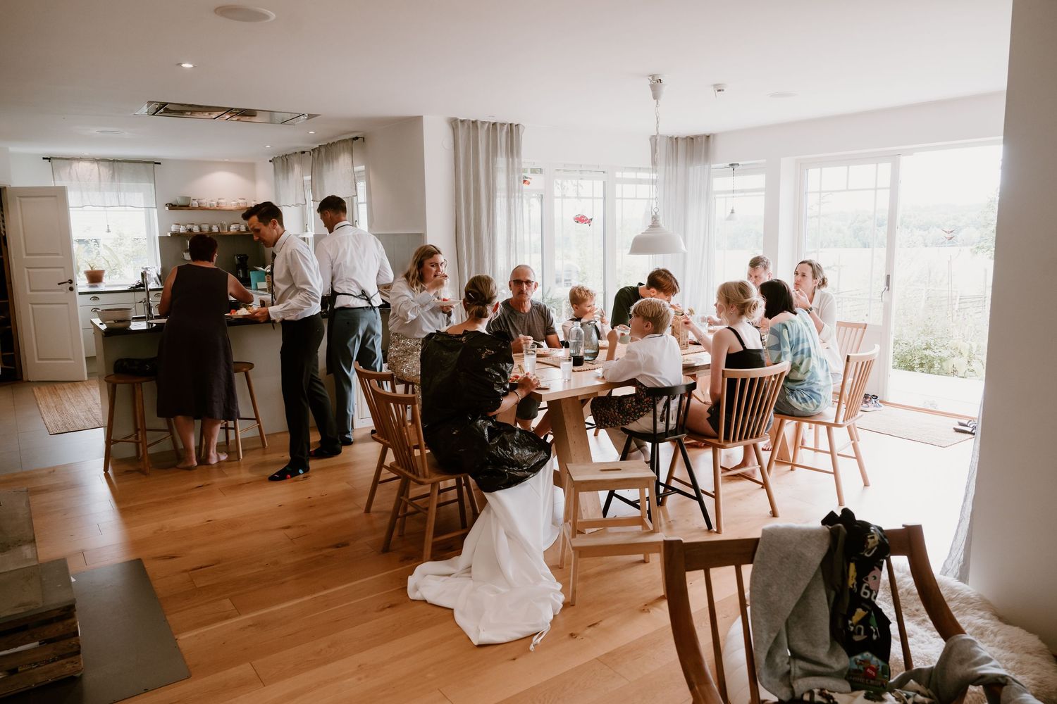 Elegant wedding reception space with hardwood floors and large windows overlooking scenic views.