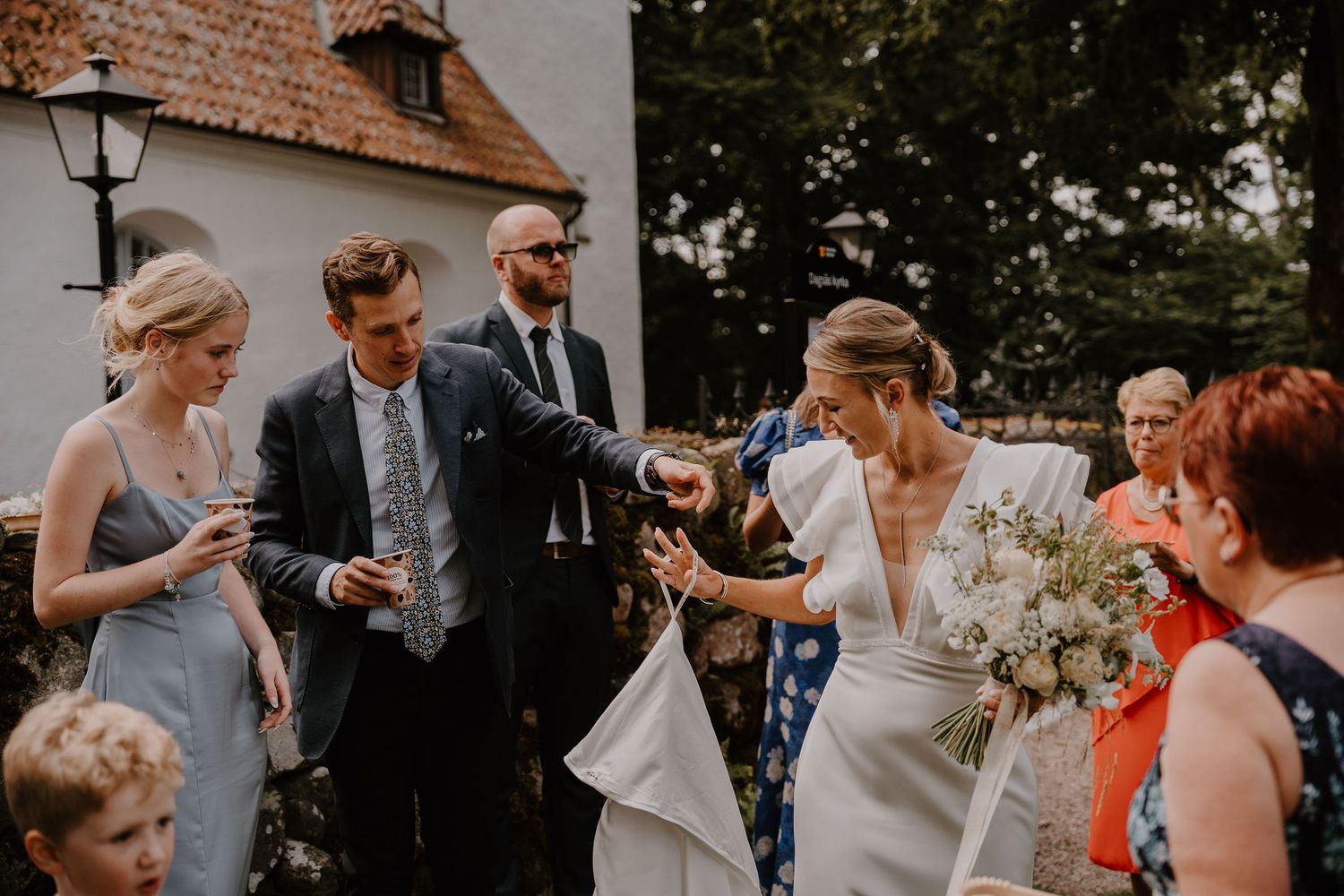 A series of candid wedding photos showing couples and guests celebrating and embracing during an outdoor celebration.
