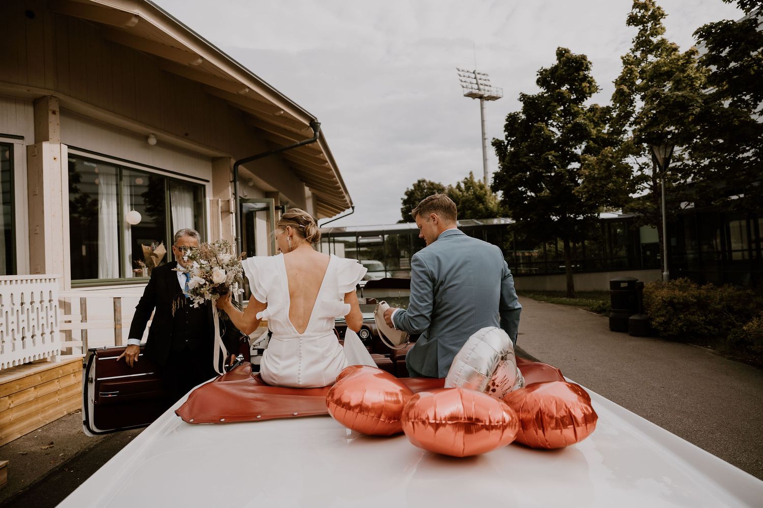 A cinematic collage of outdoor wedding venue scenes with metallic balloons and table settings at dusk.