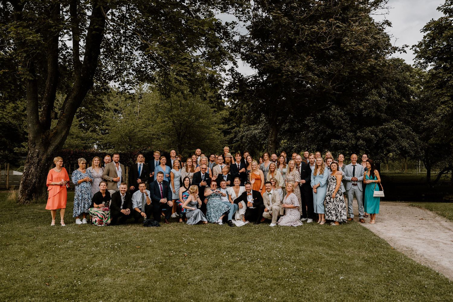 A series of outdoor group photos showing people gathered in casual attire at a scenic park or garden setting.