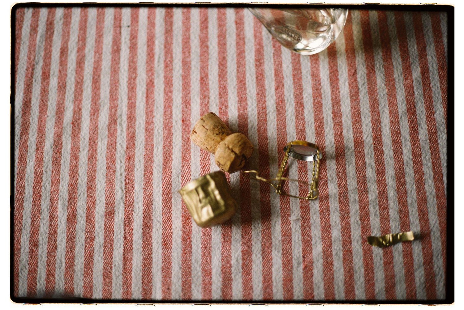 Stop motion sequence of a chocolate chip cookie being eaten on a pink and white striped background.