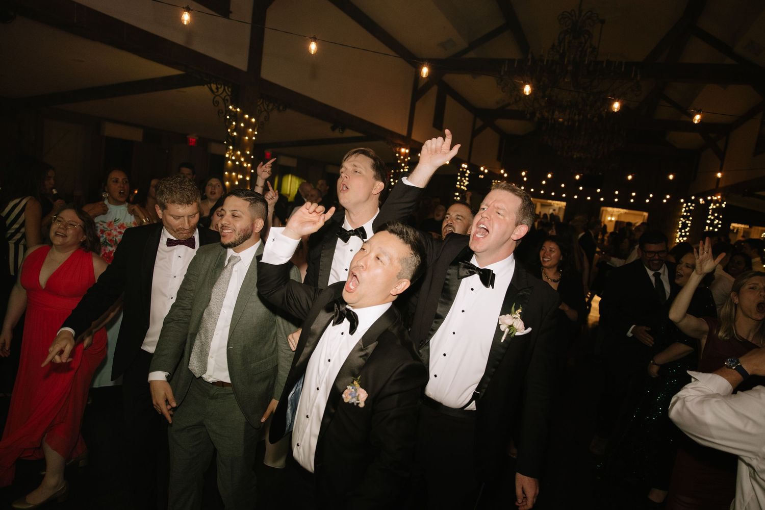 candid wedding day moment photographed by a Philadelphia wedding photographer featuring newlyweds celebrating together.