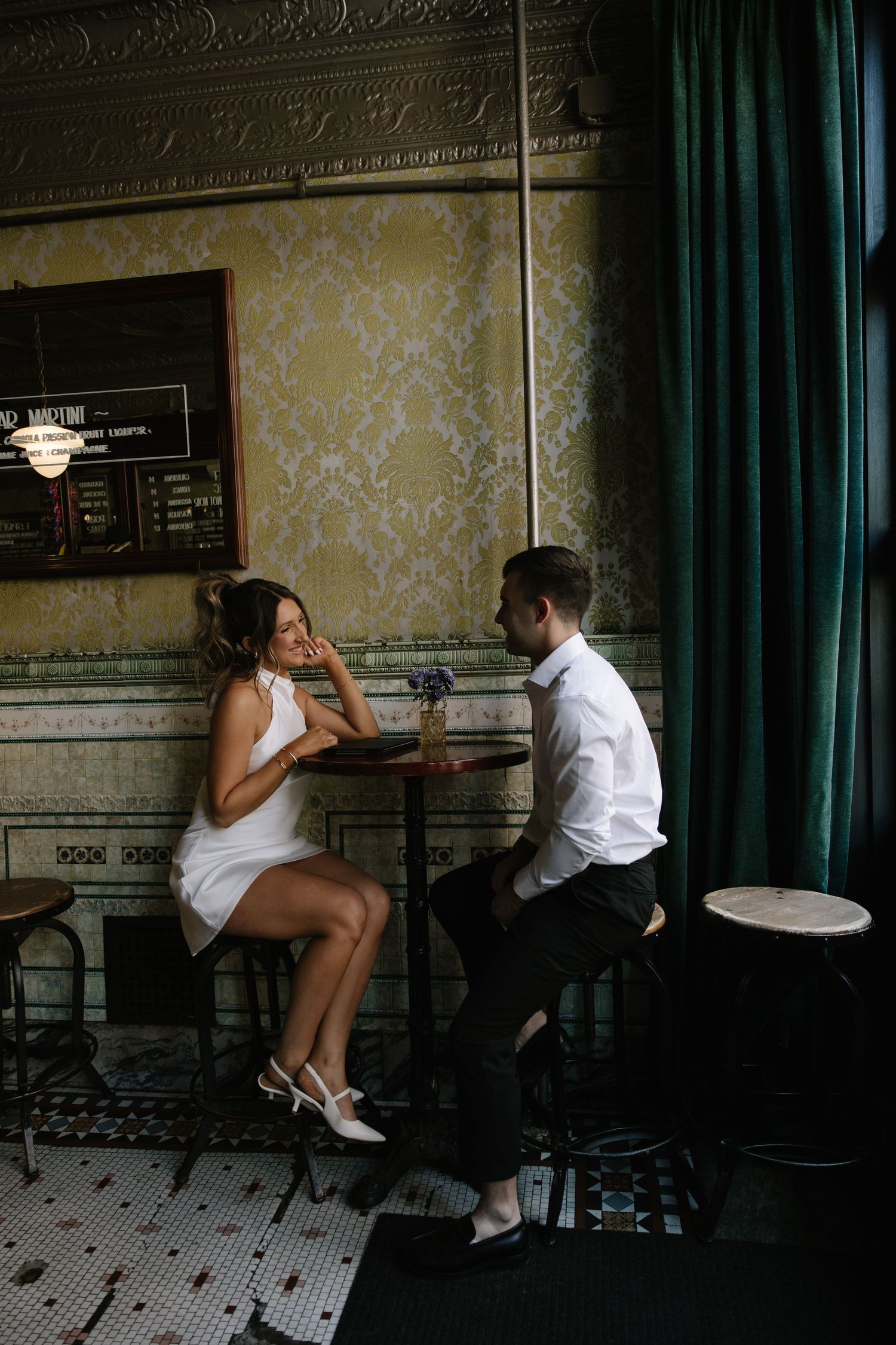 Candid spring engagement session of a couple walking along the historic cobblestone streets of Old City Philadelphia.