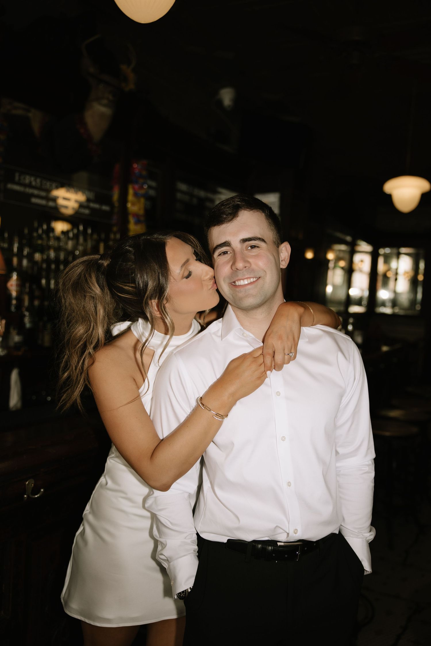 Candid spring engagement session of a couple walking along the historic cobblestone streets of Old City Philadelphia.