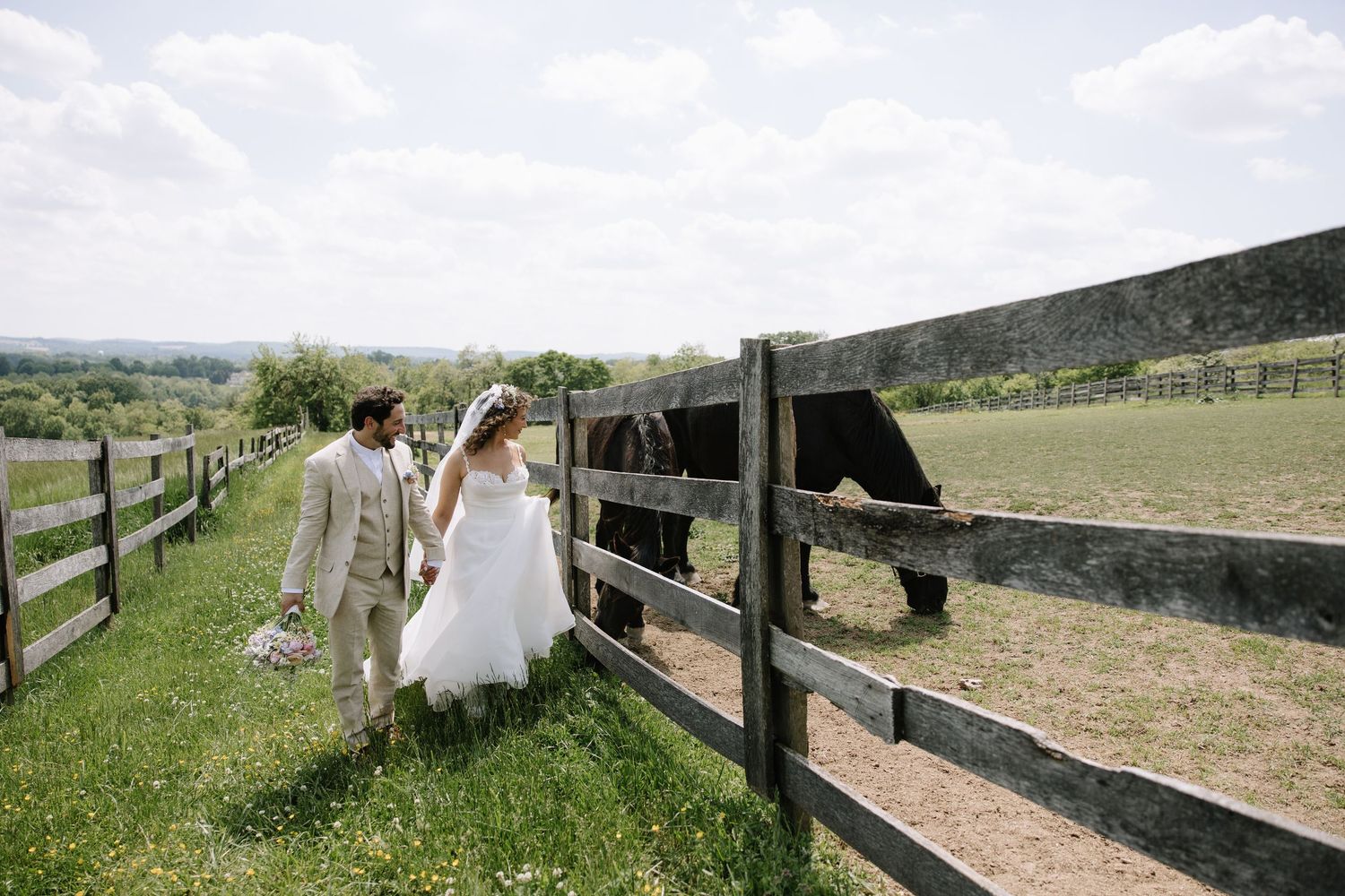 Golden hour wedding portrait of a couple overlooking the rolling hills of York County, Pennsylvania at Lauxmont Farms.