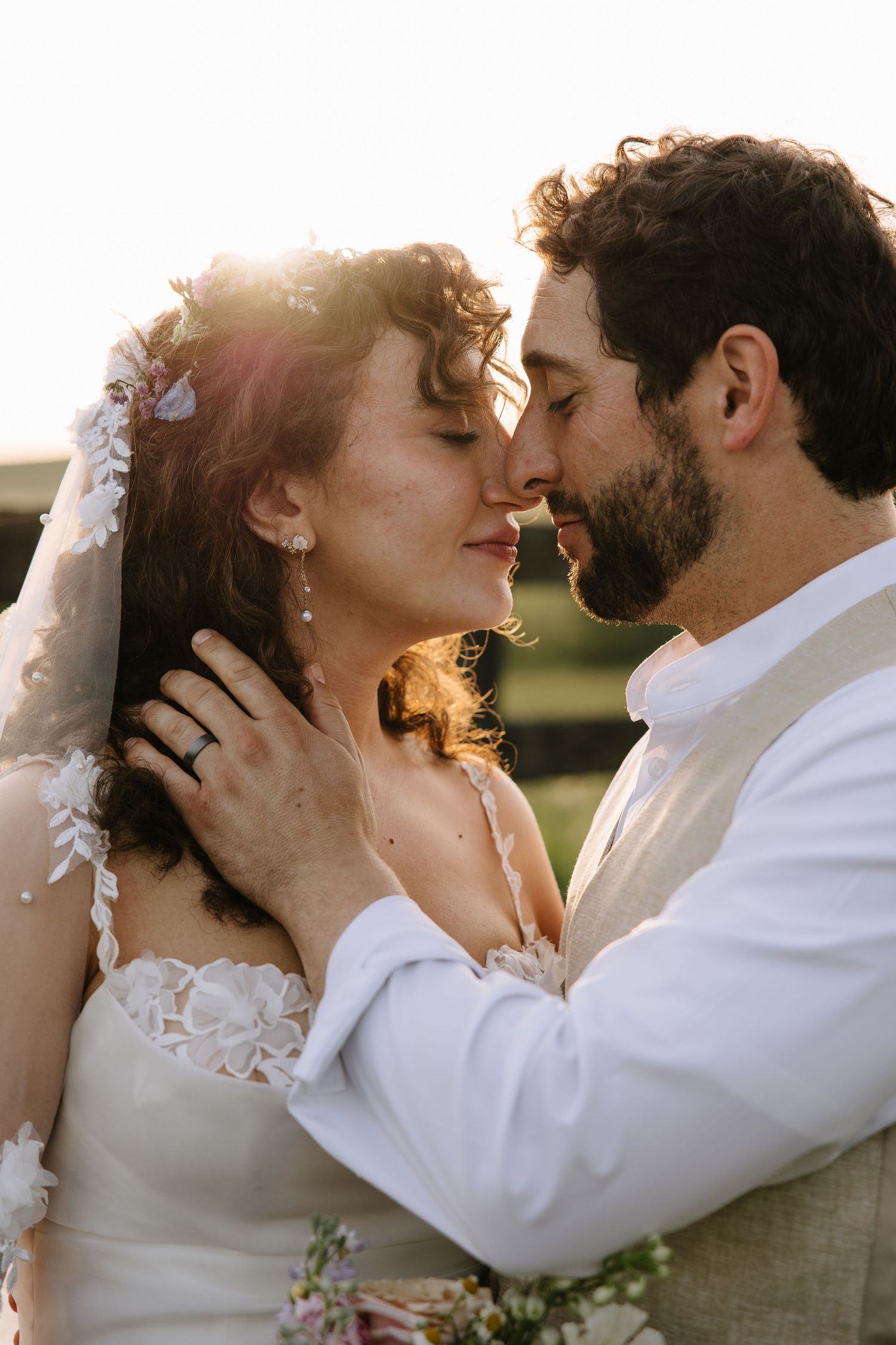 Golden hour wedding portrait of a couple overlooking the rolling hills of York County, Pennsylvania at Lauxmont Farms.