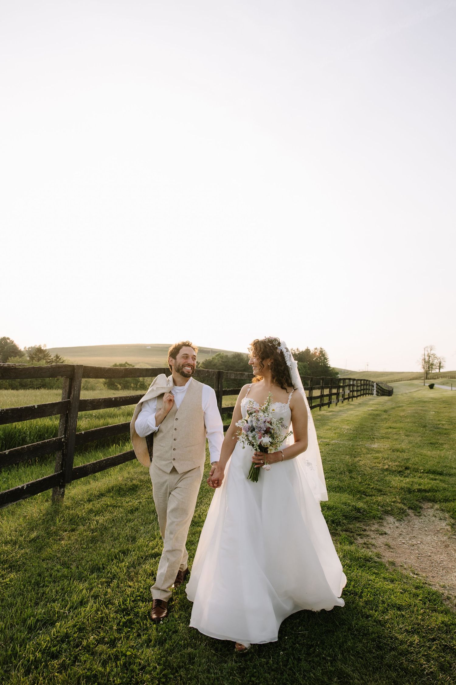 Golden hour wedding portrait of a couple overlooking the rolling hills of York County, Pennsylvania at Lauxmont Farms.