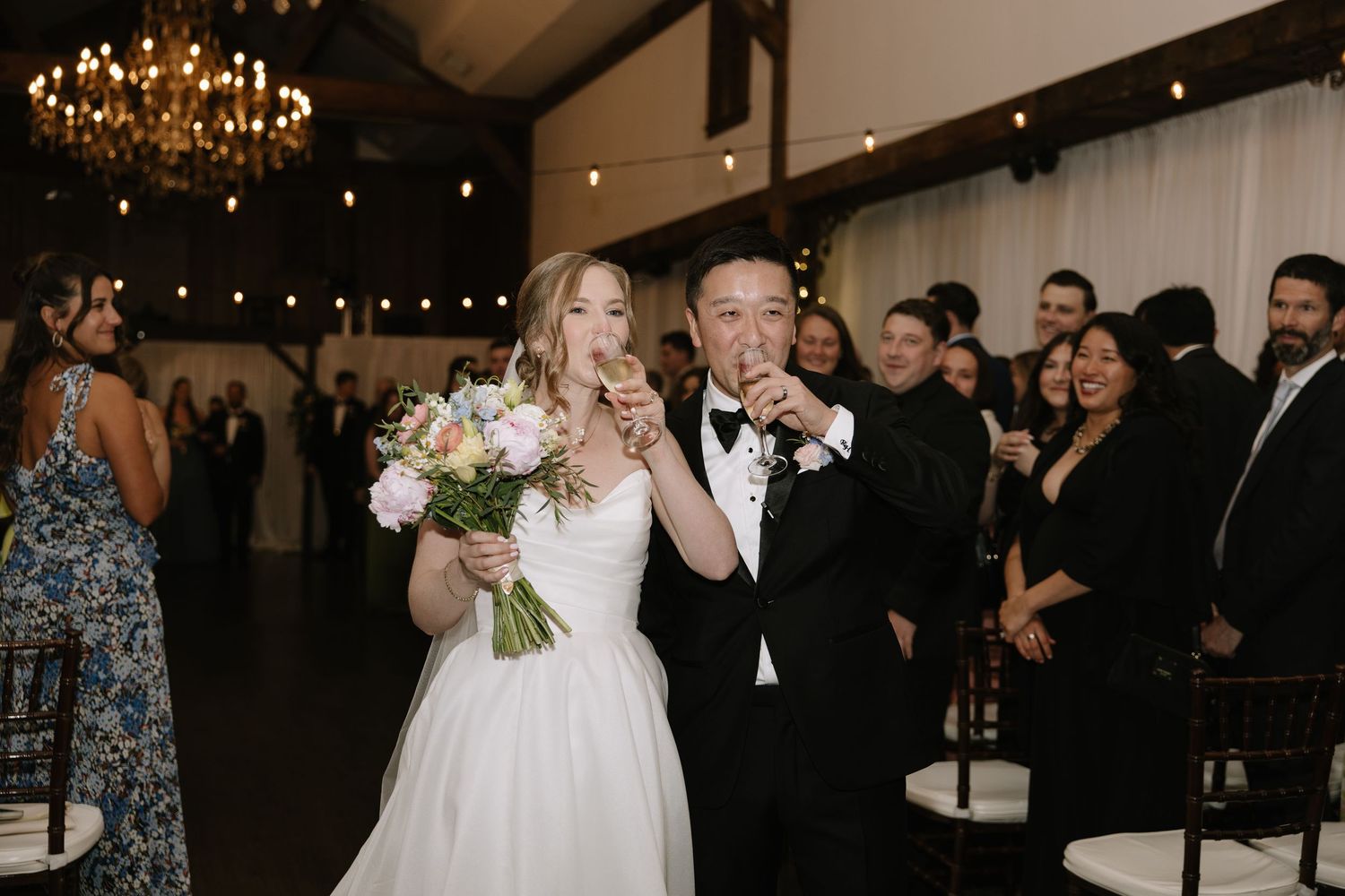 candid wedding day moment photographed by a Philadelphia wedding photographer featuring newlyweds celebrating together.