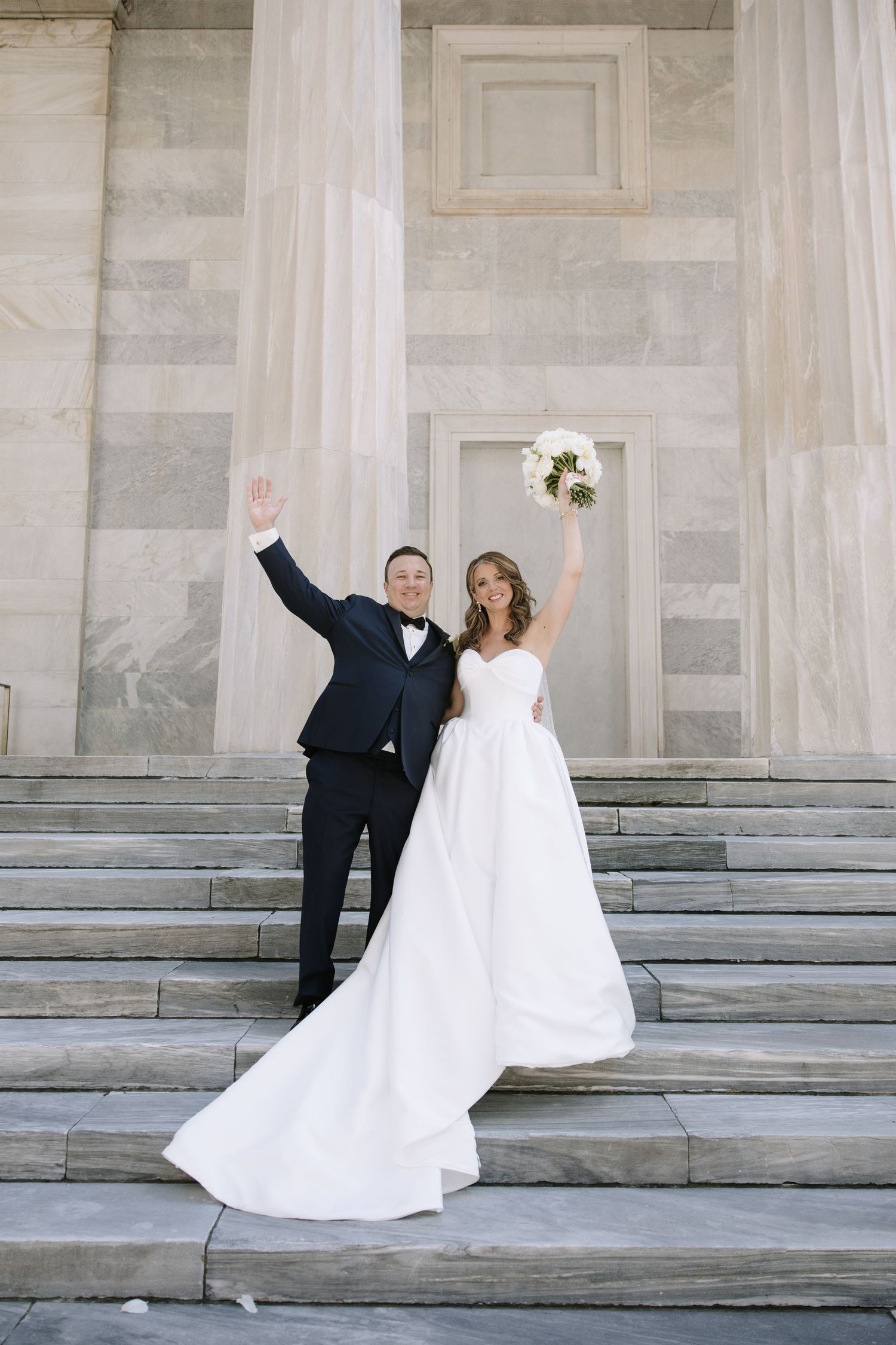Romantic wedding portrait of newlyweds inside Philadelphia's historic Union Trust venue featuring elegant architecture and timeless details.