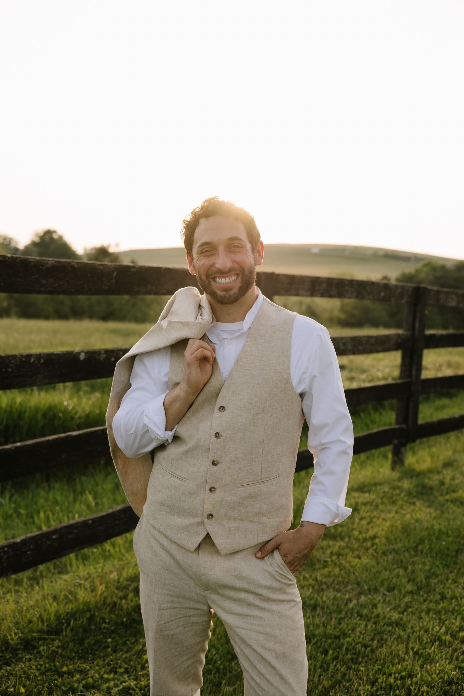 Golden hour wedding portrait of a couple overlooking the rolling hills of York County, Pennsylvania at Lauxmont Farms.