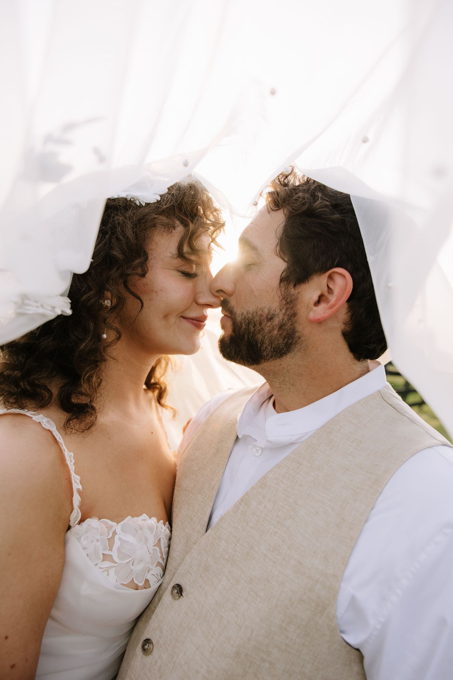 Golden hour wedding portrait of a couple overlooking the rolling hills of York County, Pennsylvania at Lauxmont Farms.