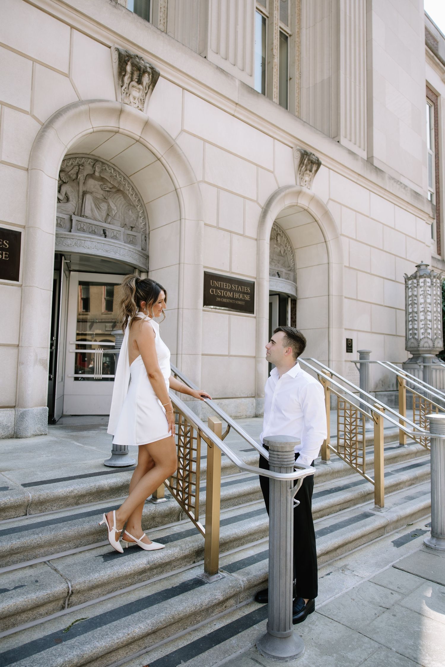 Candid spring engagement session of a couple walking along the historic cobblestone streets of Old City Philadelphia.