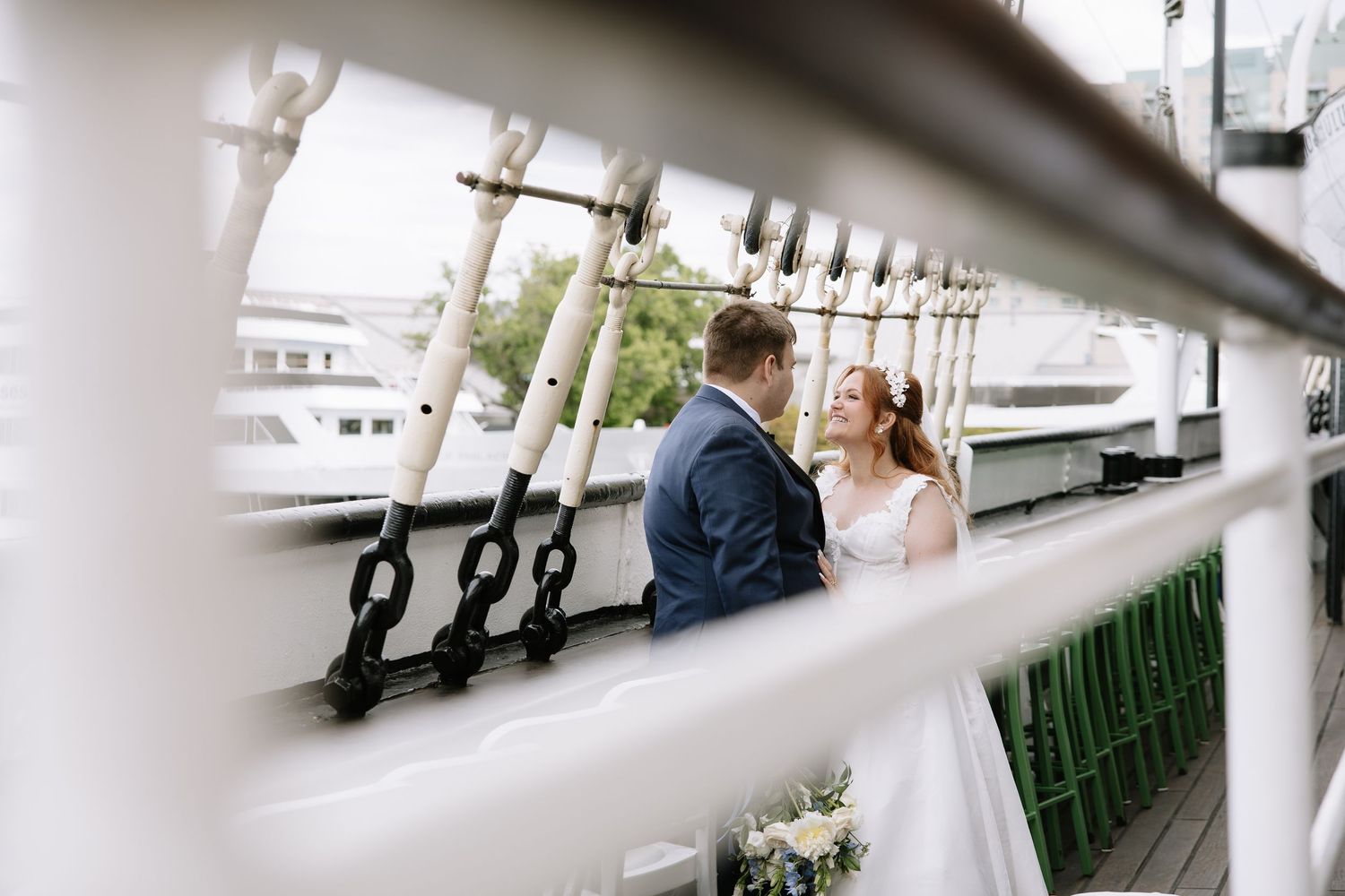 wedding portrait of a couple on the outdoor deck of the historic Moshulu tall ship in Philadelphia.