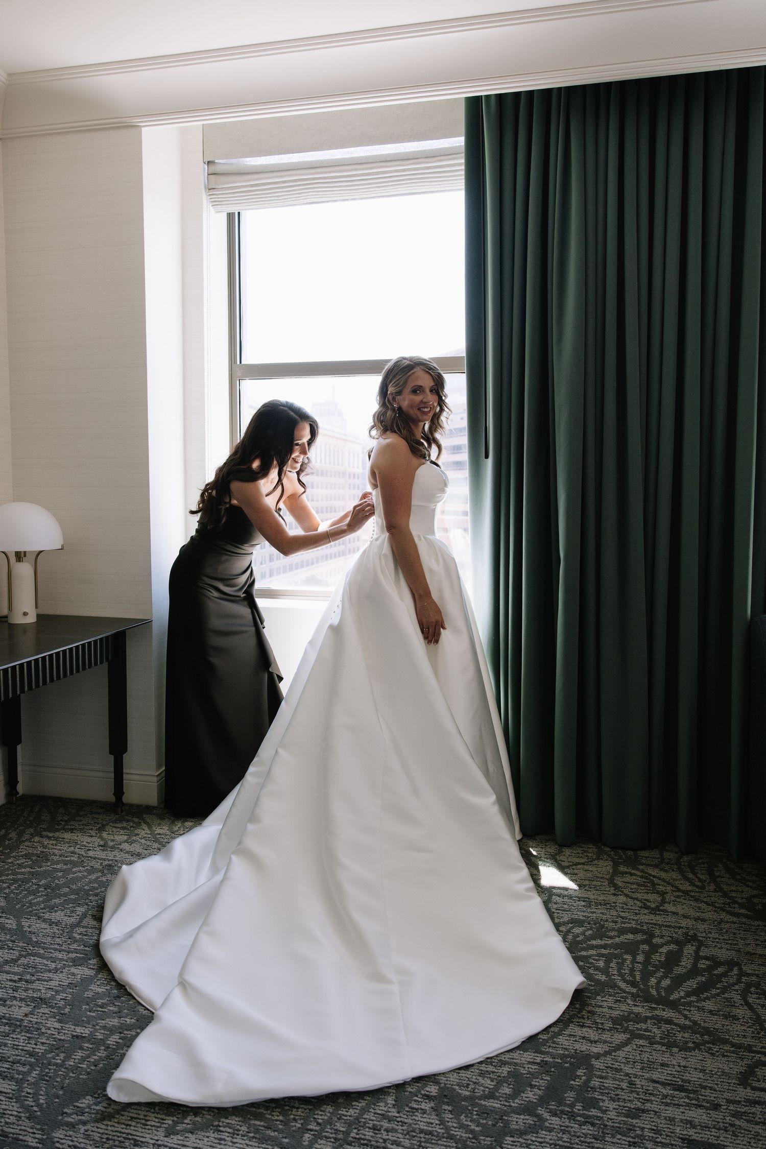 Romantic wedding portrait of newlyweds inside Philadelphia's historic Union Trust venue featuring elegant architecture and timeless details.