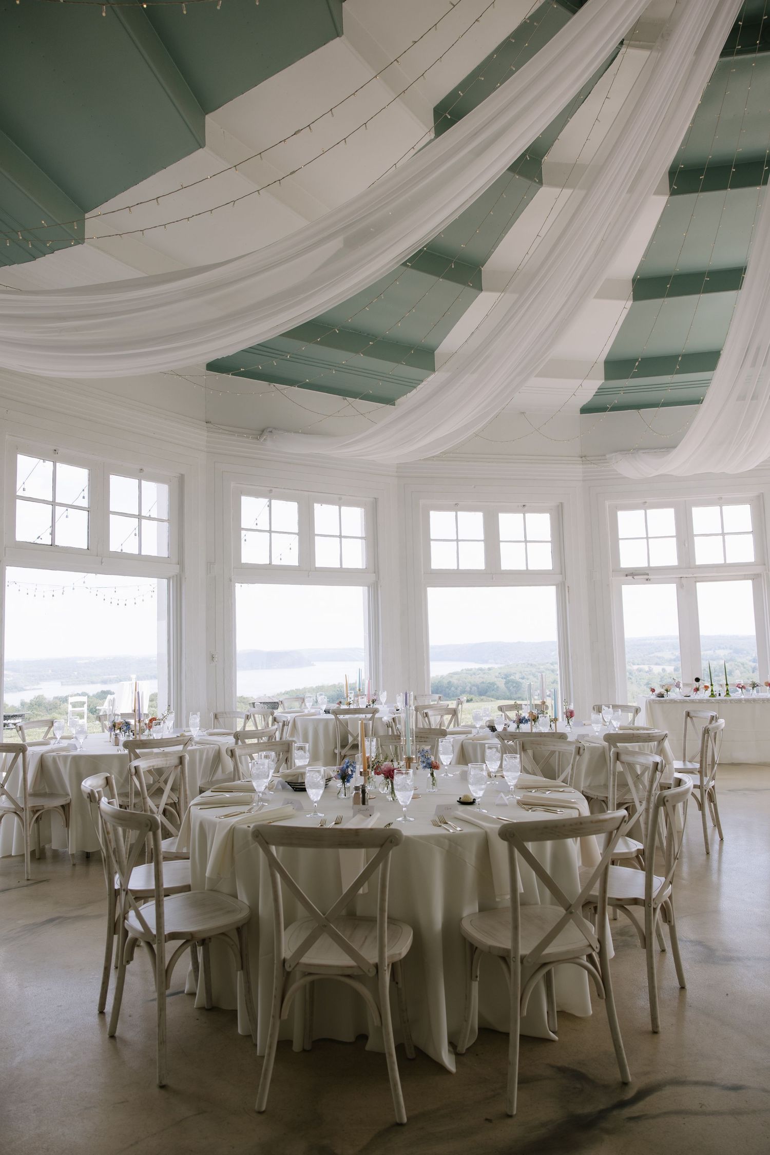 Bride and groom portrait inside the glass Rotunda at Lauxmont Farms wedding venue overlooking the Susquehanna River.