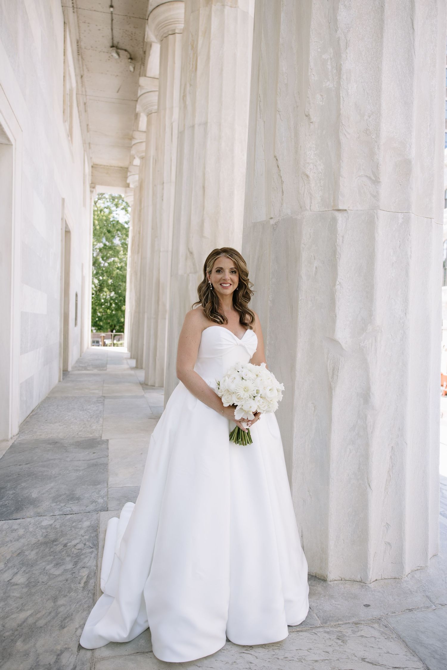 Romantic wedding portrait of newlyweds inside Philadelphia's historic Union Trust venue featuring elegant architecture and timeless details.