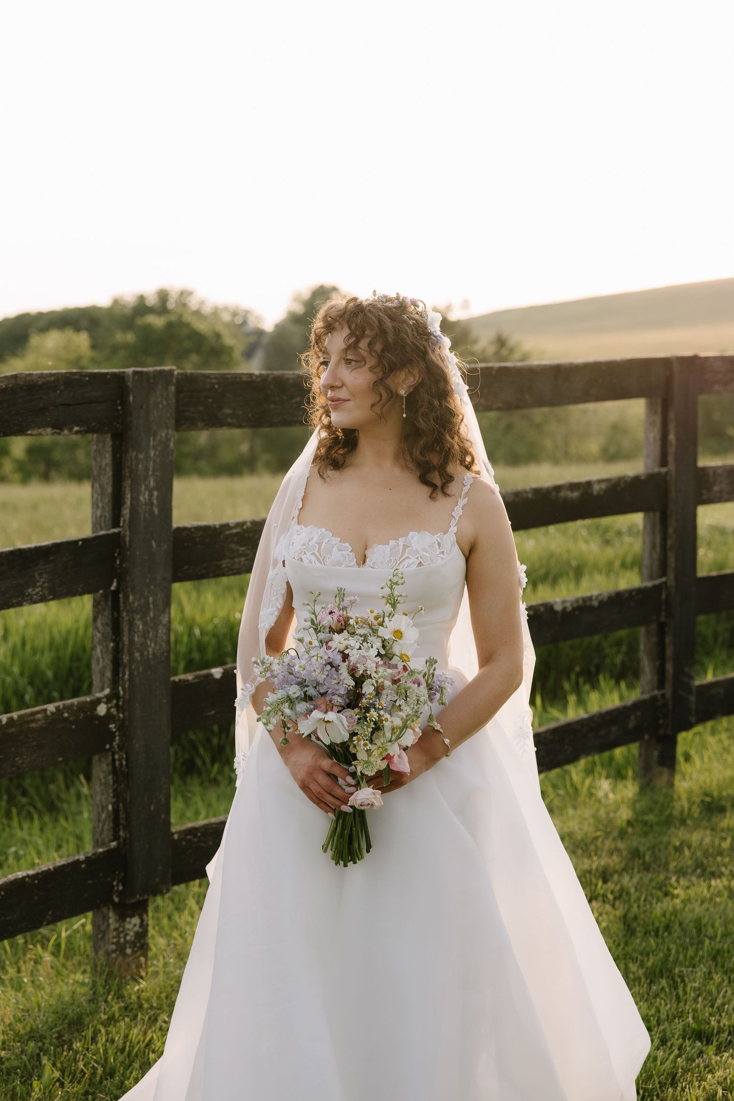 Golden hour wedding portrait of a couple overlooking the rolling hills of York County, Pennsylvania at Lauxmont Farms.