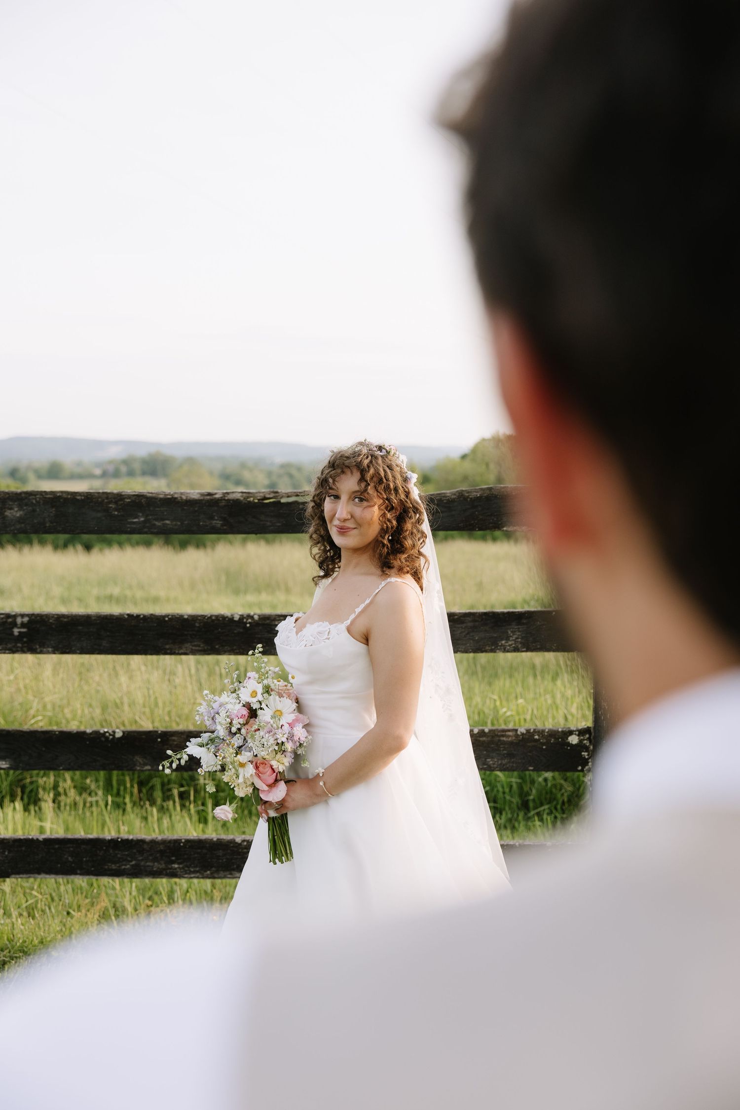Golden hour wedding portrait of a couple overlooking the rolling hills of York County, Pennsylvania at Lauxmont Farms.