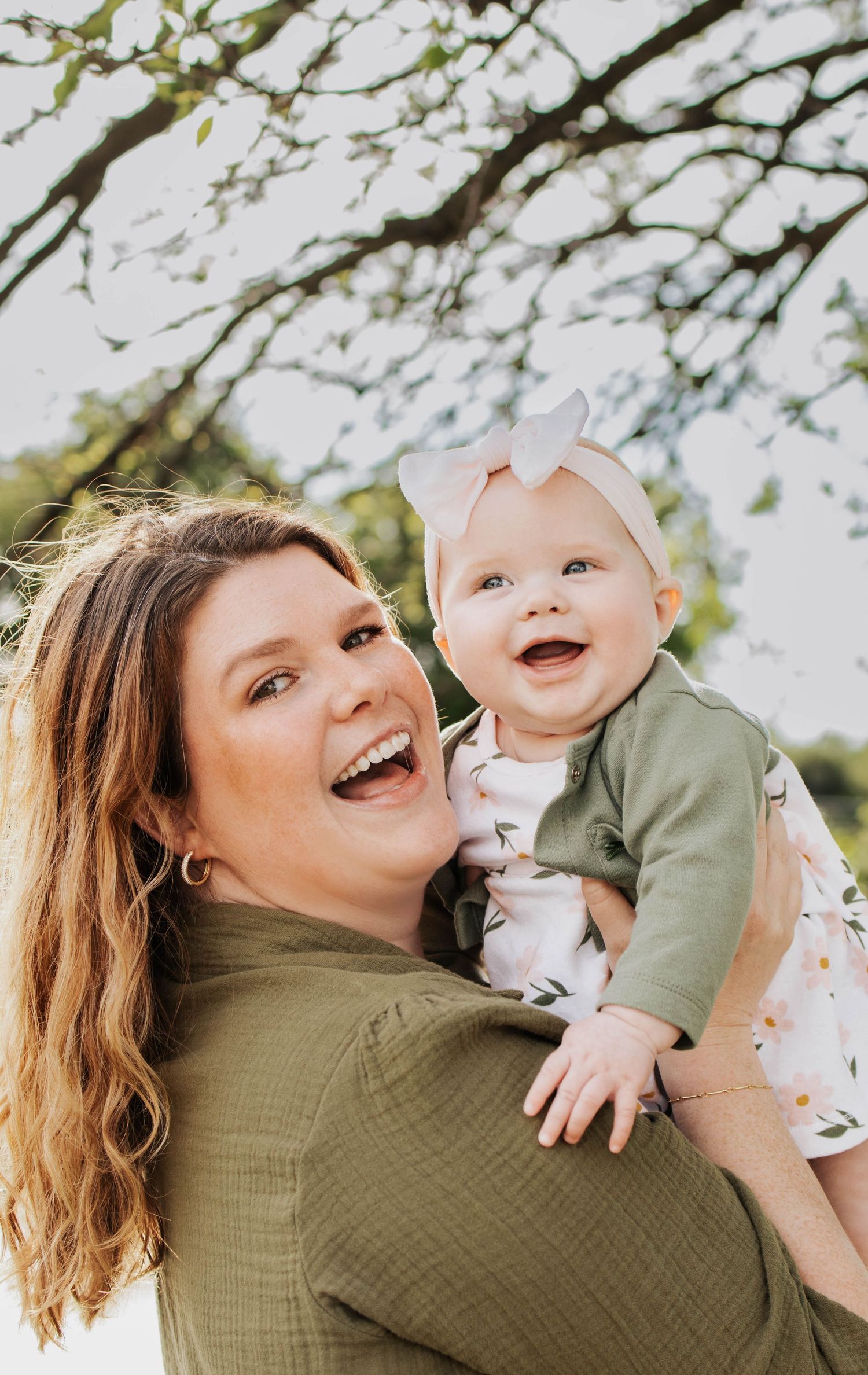 Mother and infant daughter smiling for family photos in Troy, MO
