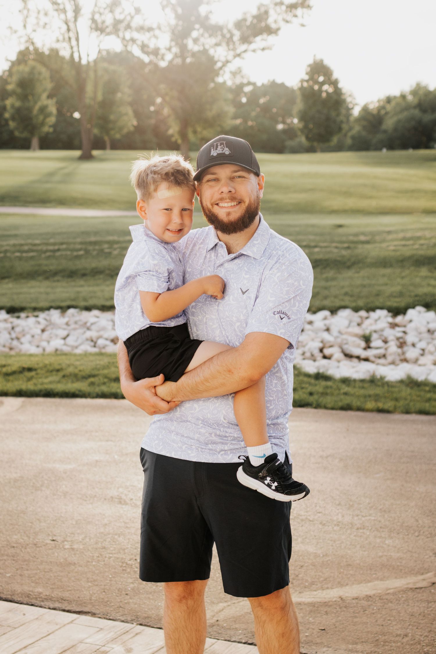 Father and son in matching golf polos in Troy, MO
