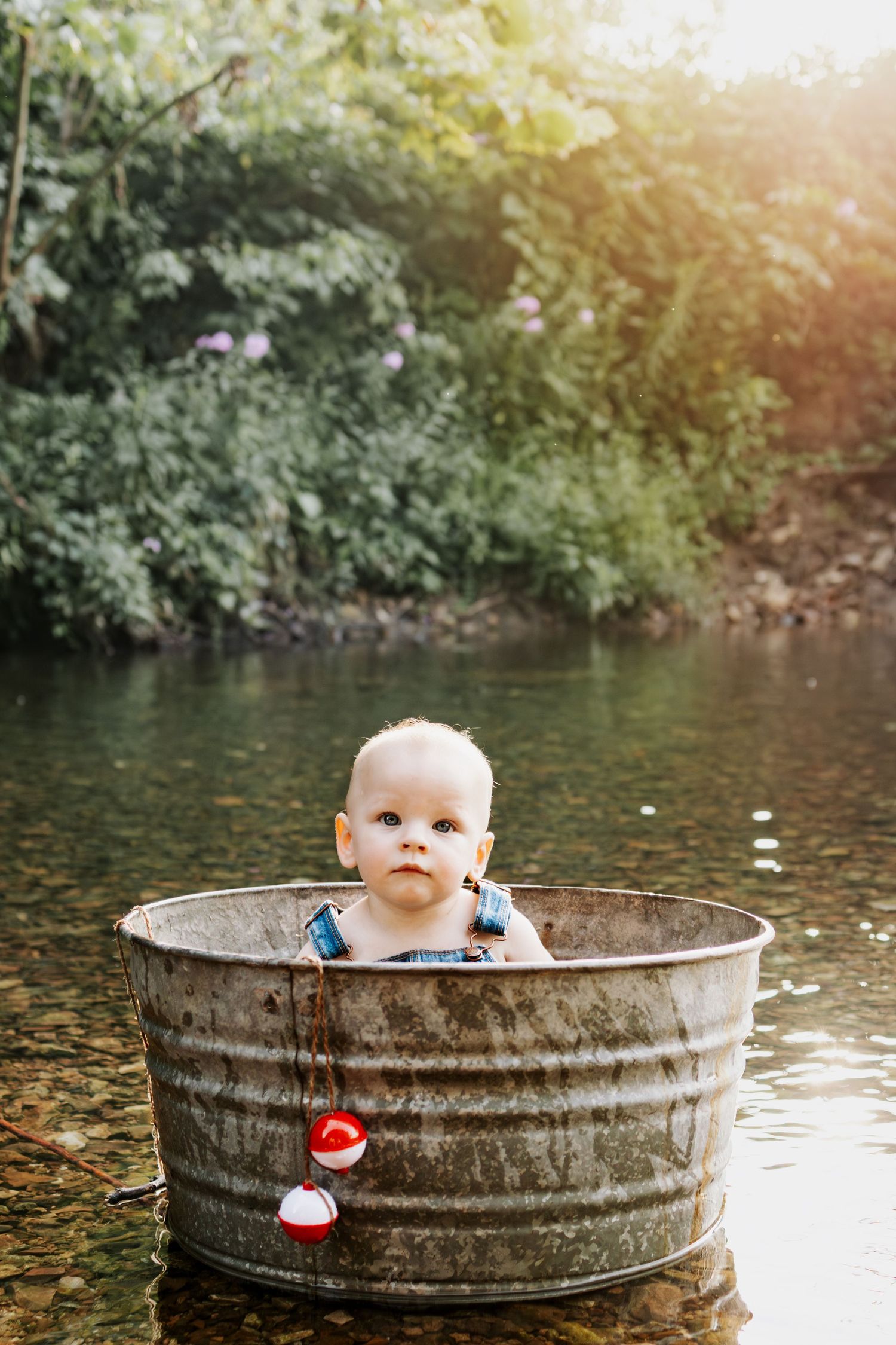 1 year old baby in creek for his 1st birthday milestone session at Indian Camp Creek in Foristell, MO