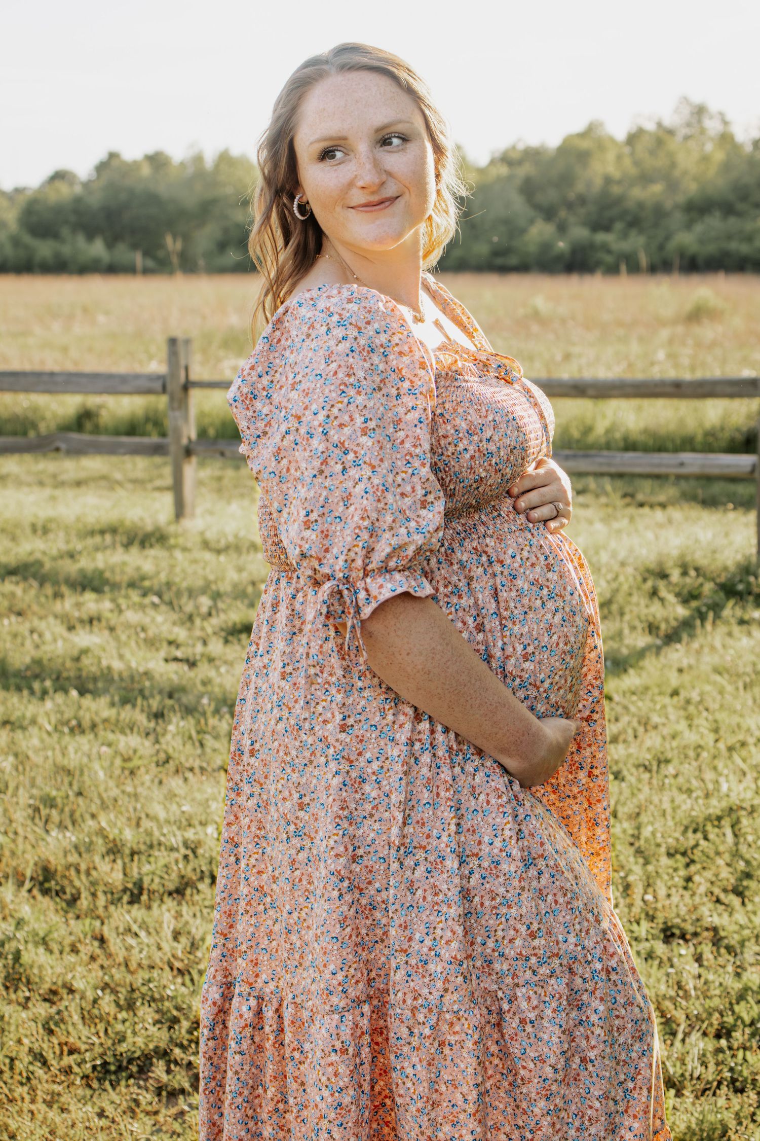 Pregnant mother celebrating her pregnancy outdoors in a maternity session in Foristell, MO at Indian Camp Creek Park