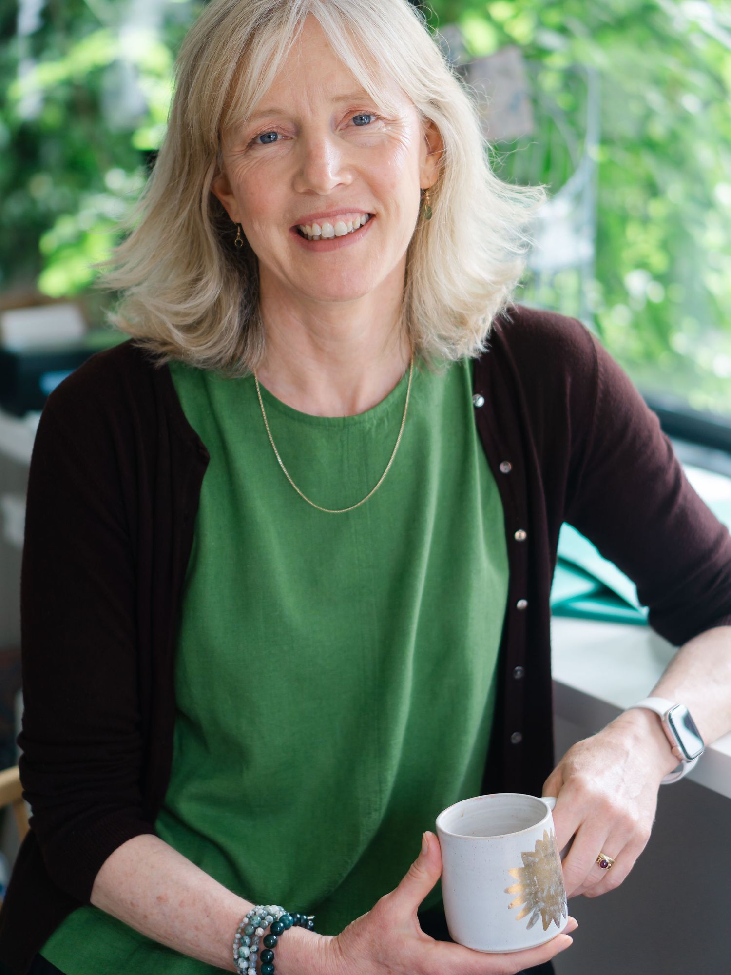 Newton Abbot based illustrator Linda Fox, relaxed and smiling on her brand shoot with Felicity billen
