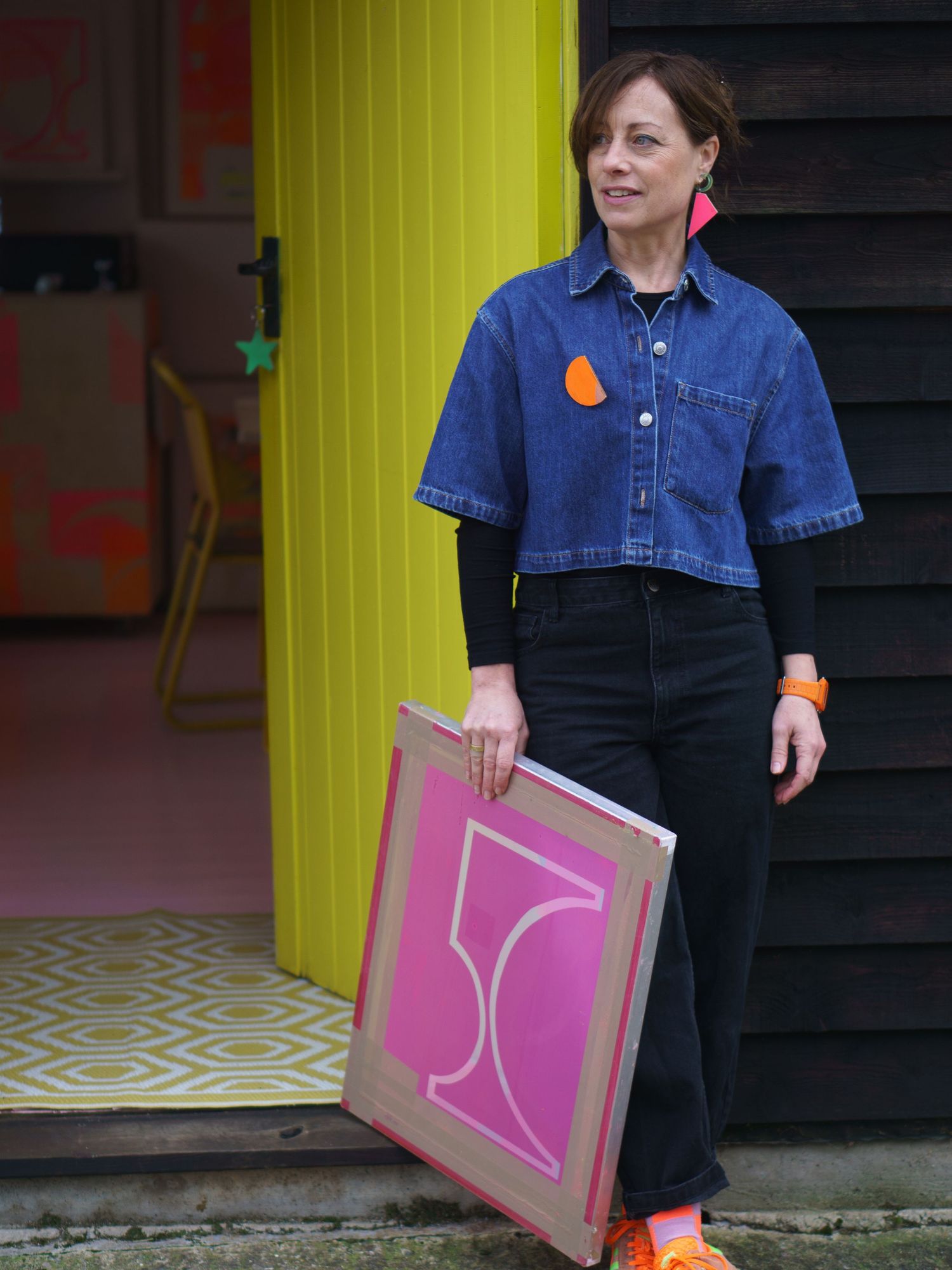 Risograph printer Jo Norman standing outside her studio, looking relaxed and happy on their brand photography shoot with felicity Billen
