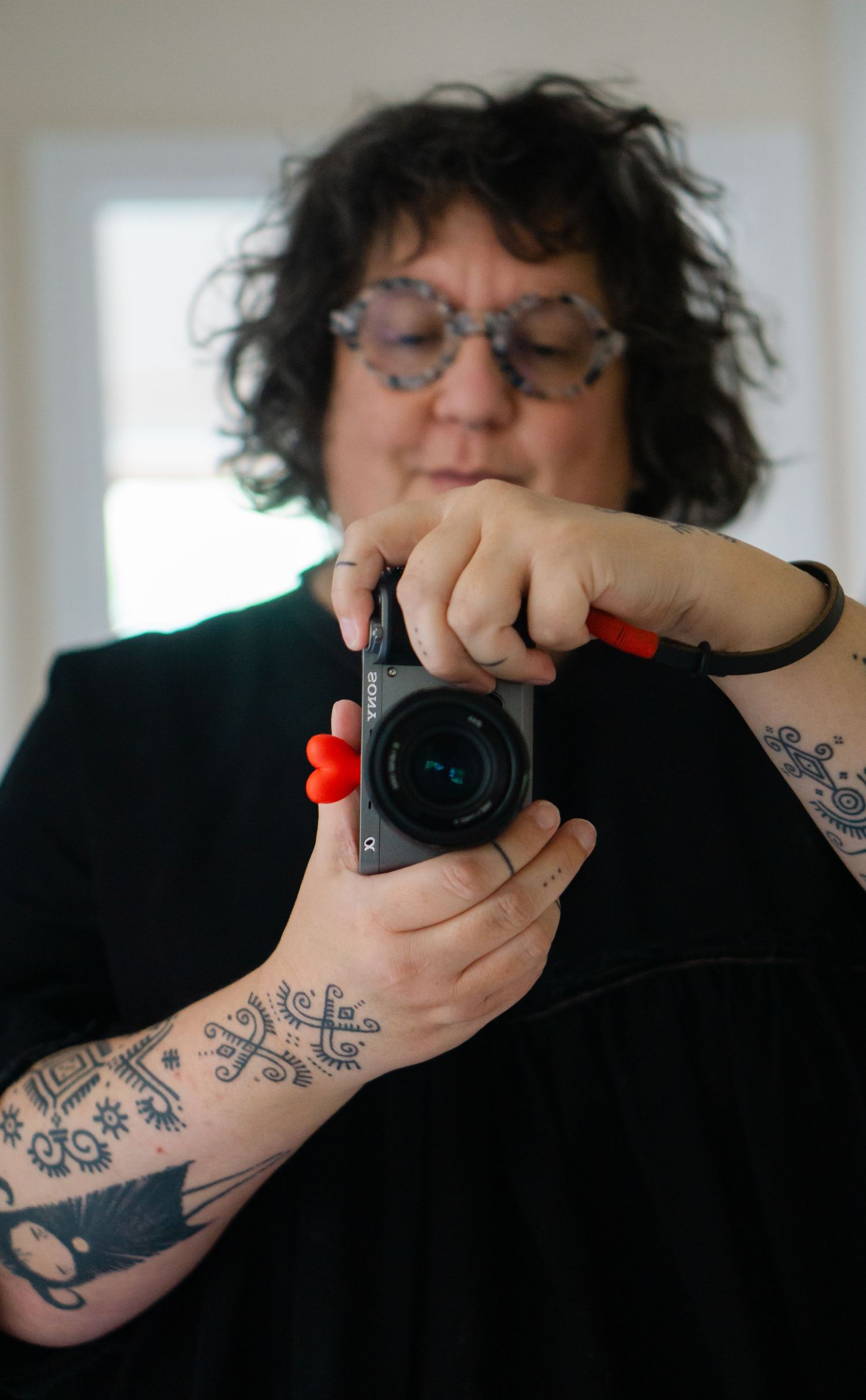 Devon based Brand portrait photographer Felicity Billen smiling behind  her camera in a mirror selfie