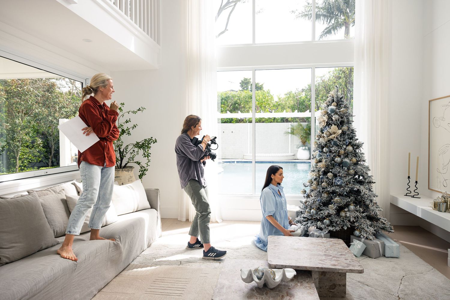Camera crew filming lifestyle content indoors, behind the scenes.