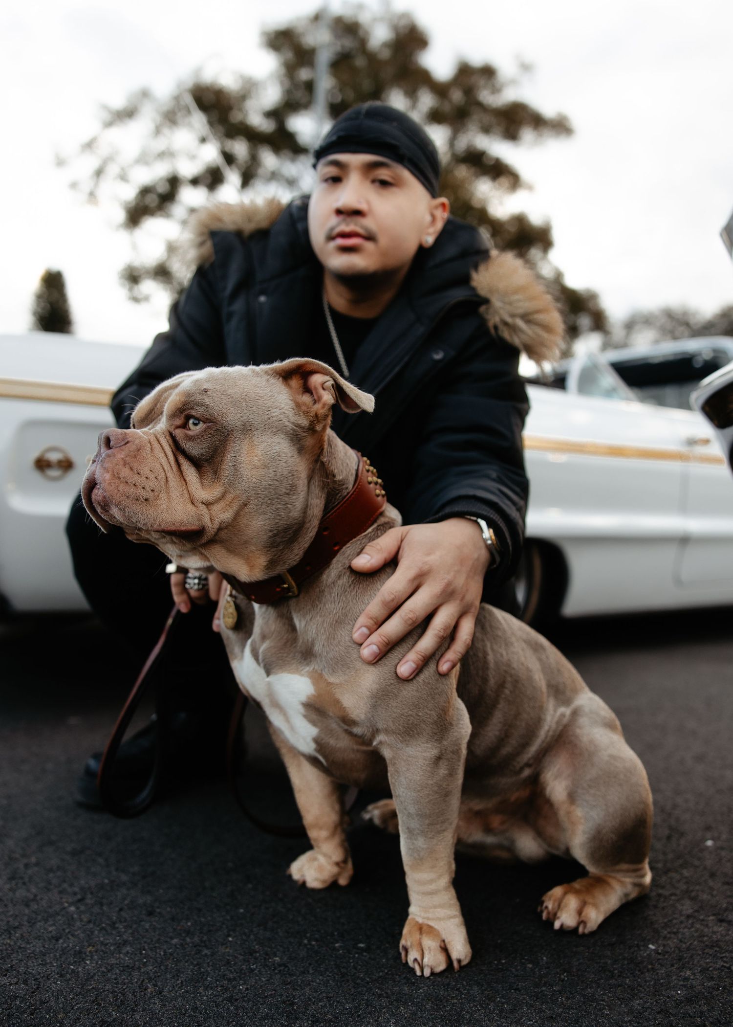 Outdoor lifestyle portrait of man with dog, casual candid moment.
