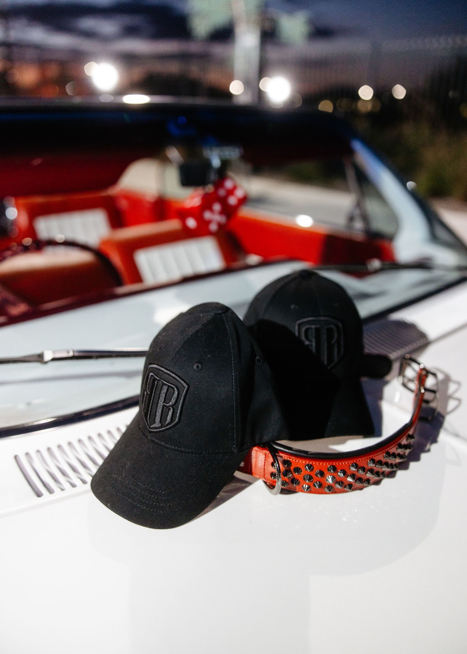 Interior shot of classic car, focus on polished steering wheel.