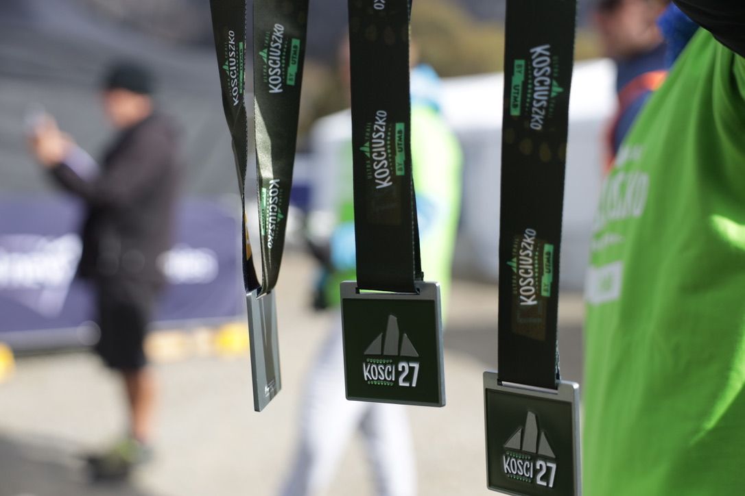 Close-up of race medals on display at sports event.