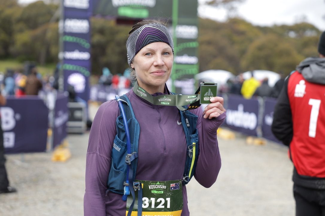 Portrait of female athlete with a medal, captured after an ultratrail.