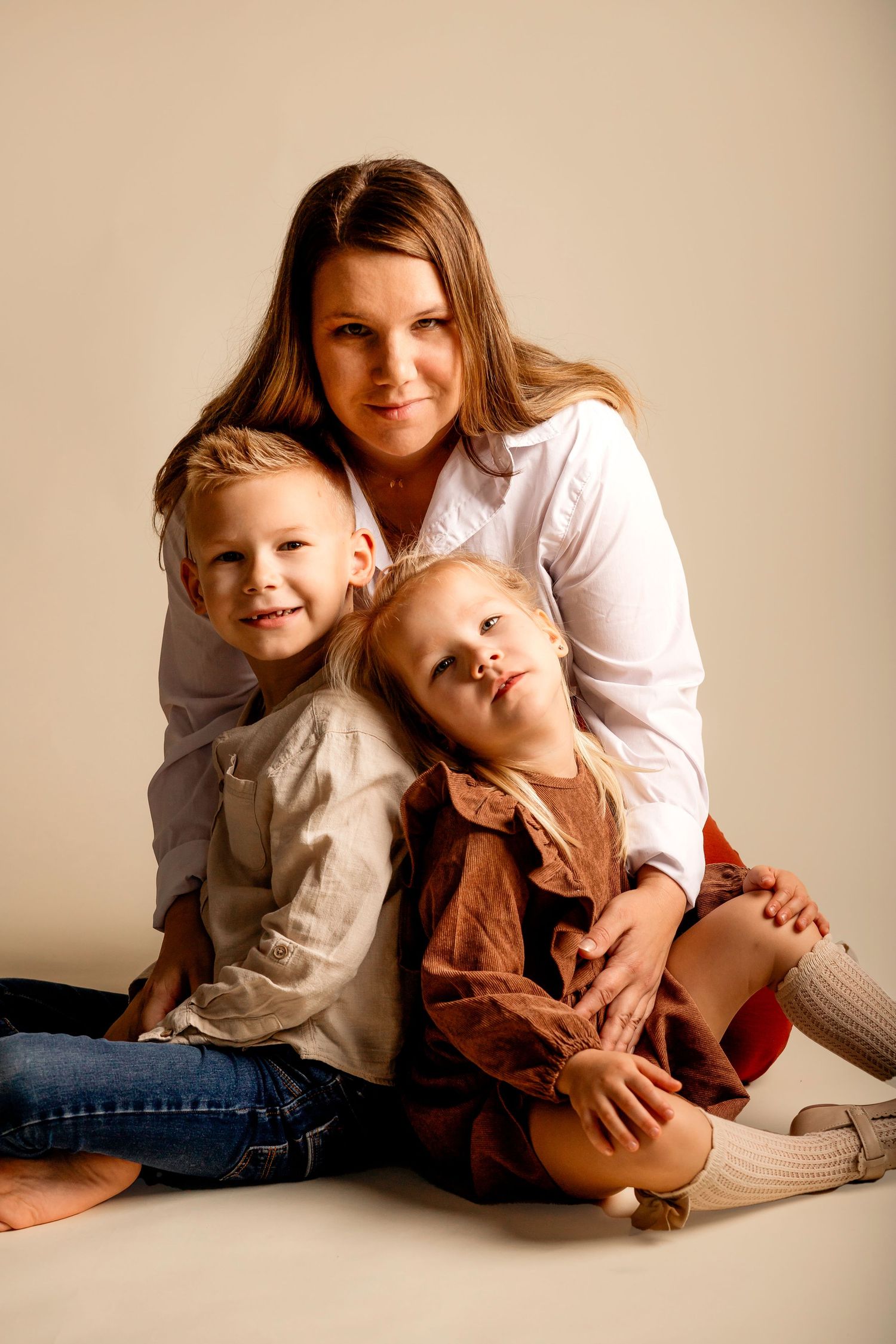 A series of warm-toned studio photos showing tender family moments with casual clothing against a neutral backdrop.