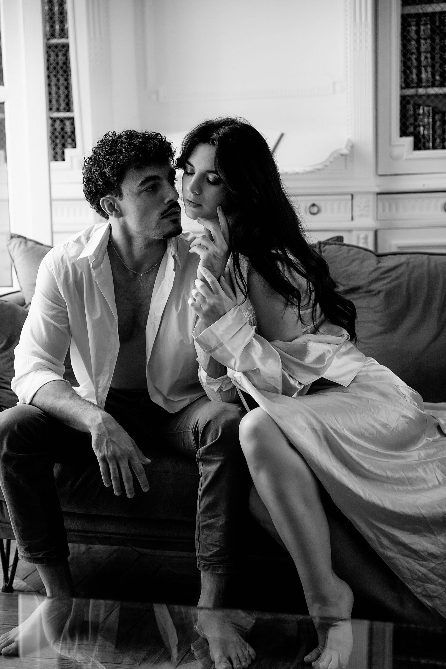 Black and white photo series showing intimate romantic moments between a couple on a couch.