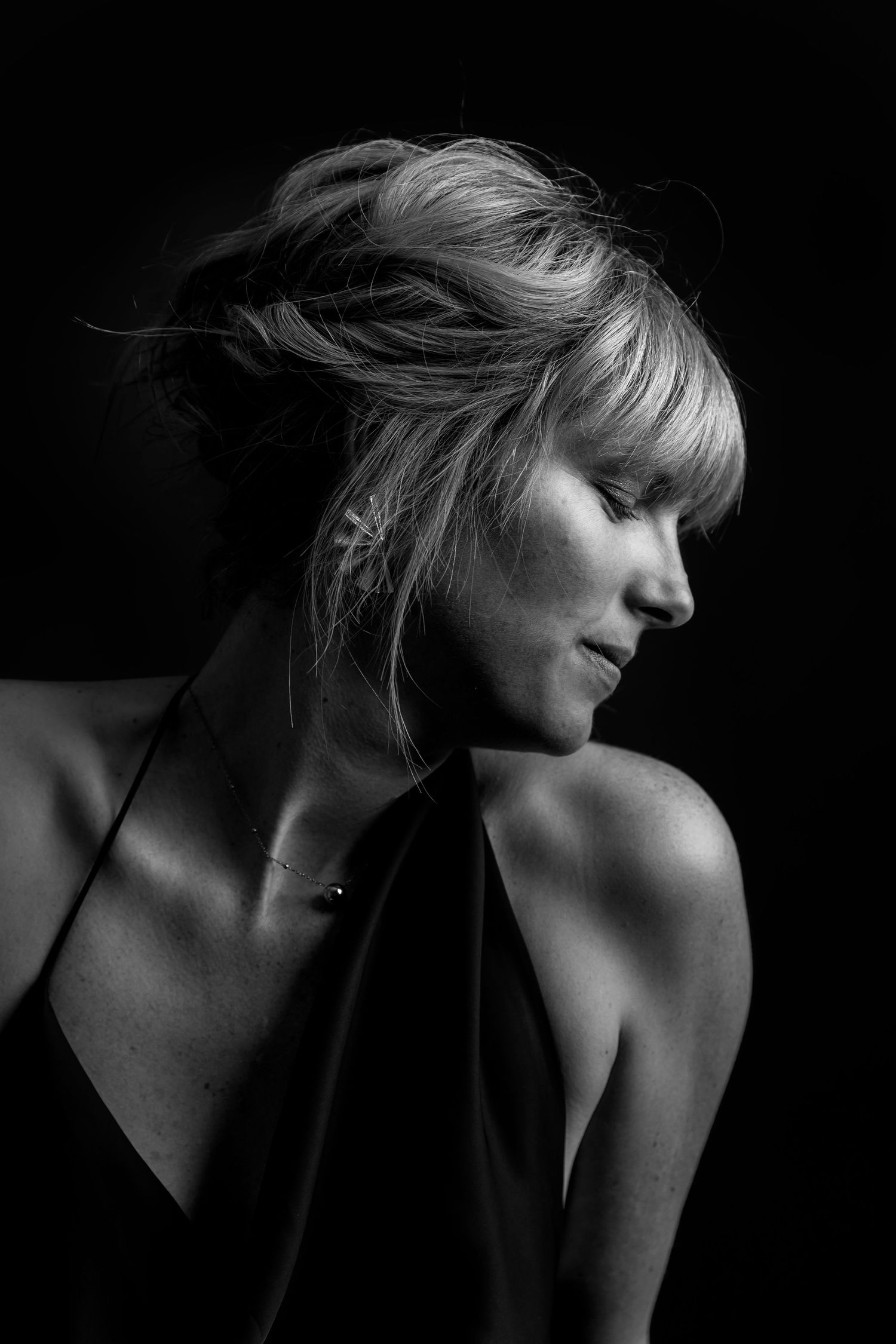 A dramatic black and white artistic portrait series showing a silhouetted figure against a dark background.